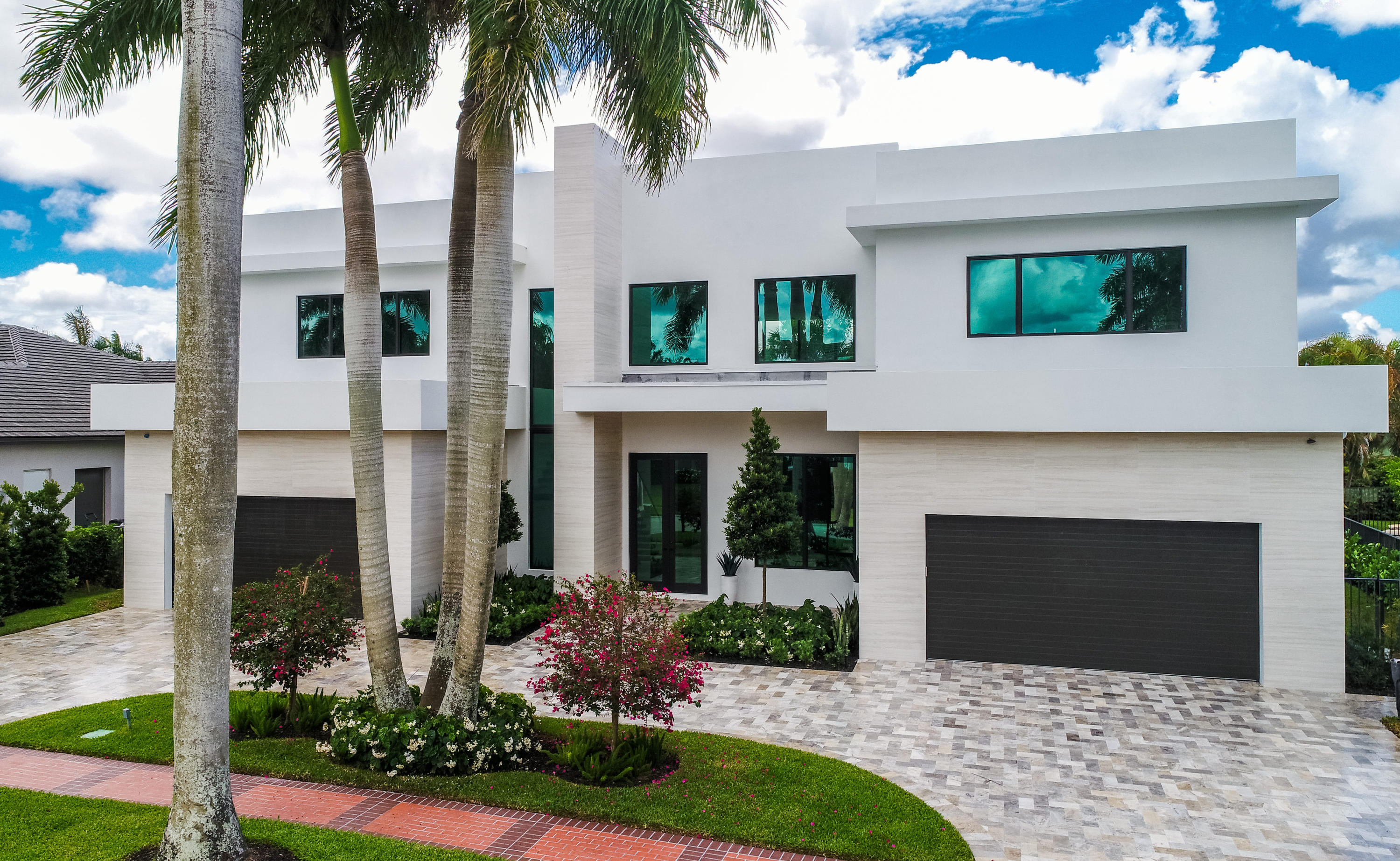 NEW CONSTRUCTION. Built by award winning Developer with interiors designed by Michael Gray Interiors, this modern masterpiece blends current architectural design with classic Florida living.  Indoor-outdoor living perfect for entertaining, and an open floor plan of glass walls, this meticulous and deliberate composition delivers expansive views of the emerald green fairways and winding waterways of St. Andrews Country Club. A resort style pool, covered loggia and summer kitchen outfit the lushly landscaped exterior. Featuring 6 bedrooms, 7 full baths, 3 half baths with 7269 sq-ft of air-conditioned spaces, this custom-built 9000 sq-ft home provides the highest quality finishes throughout. The grand master suite with chic his and her baths and generous closets, provide the new Owner with first floor access to the expansive sun-filled entertaining areas which connect seamlessly to the gourmet quality chef's kitchen with grand center island. An office and en suite guest bedroom complete the downstairs level. An architecturally significant floating glass staircase leads to the second level featuring 4 en suite bedrooms, compelling gathering spaces for family and friends, and a separate media room. Other features include poured concrete second level, hurricane impact windows and doors, full house generator, elevator, and four-car garage. The information herein is deemed reliable and subject to errors, omissions and changes without notice. All measurements are approximate