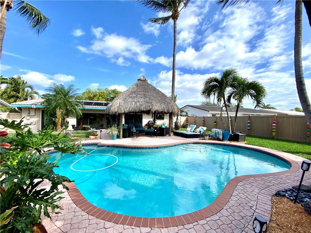 **Tropical South Florida oasis*perfect for Air BnB**2/2 single family home with no HOA and no restrictions in desirable Garden Isles*walk to restaurants, Publix supermarket*5 minutes to the amazing beach with the new pier and a multitude of casual and fine dining options all within a few blocks*1 car garage with oversized paver driveway*Spacious layout with 2 dining areas*separate inside laundry/storage room*huge fully fenced yard (PVC/vinyl privacy fence)*newer free-form pool & new Tiki hut with TV & electric*hurricane impact windows & sliders throughout*6 year old central A/C*furnishings negotiable*see broker remarks all ages, no HOA, no restrictions