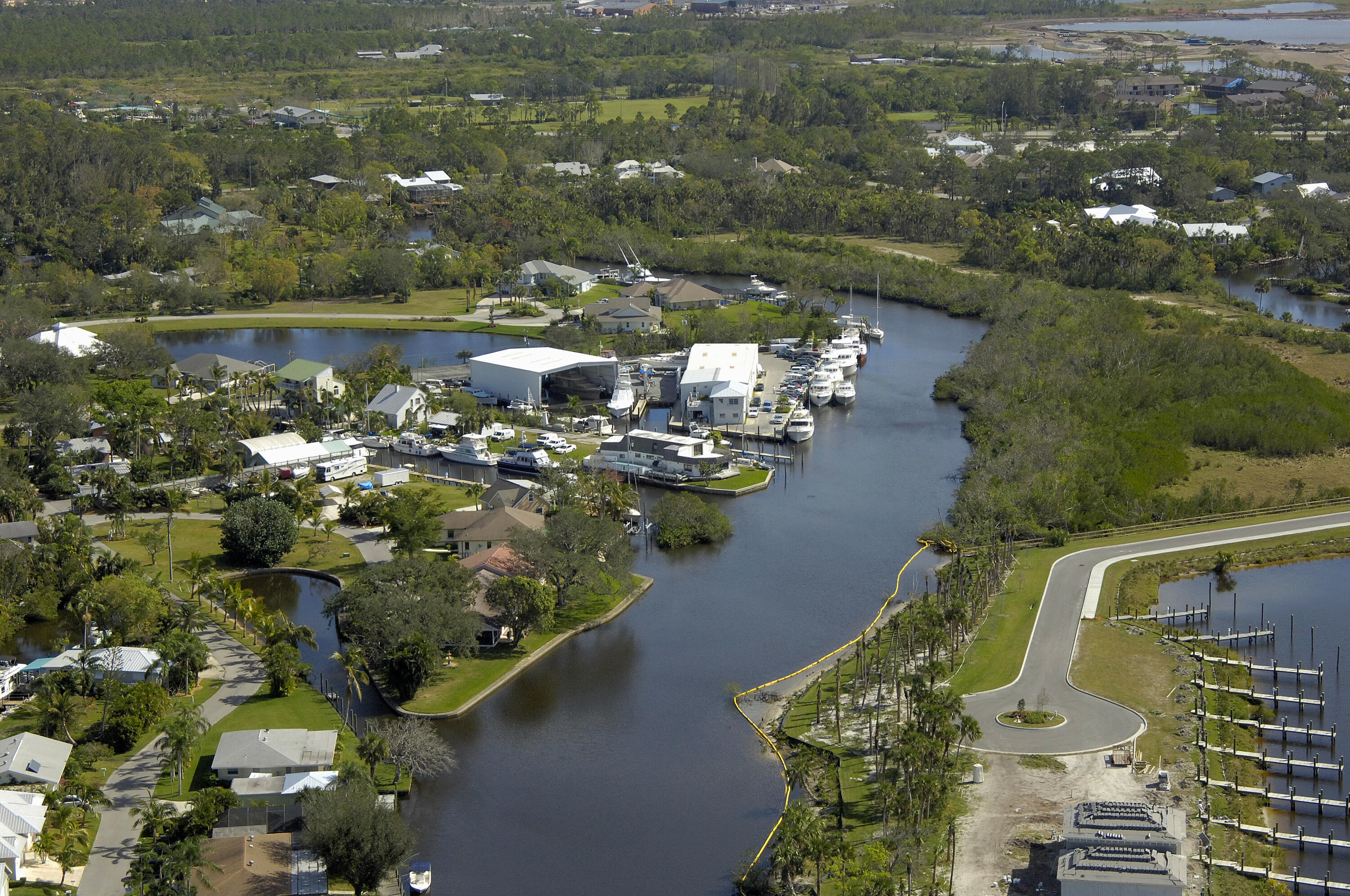 Exceptional and rarely available, this 2.66-acre R-2 zoned property offers 193 feet of direct deep-water frontage along the scenic St. Lucie River. With expansive acreage and flexible zoning, the property presents a rare opportunity to create a private waterfront estate, a multi-residence compound, or multiple single-family homes—an increasingly valuable offering in today's market where large, buildable waterfront parcels are limited. Positioned on deep, navigable water, the property allows for effortless boating access to the Atlantic Ocean via the St. Lucie Inlet, as well as westward passage across Florida through Lake Okeechobee and the lock system. The depth and width of the waterway make it ideal for accommodating larger vessels, further enhancing its appeal for boating enthusiasts and those seeking a true waterfront lifestyle.  Set in a quiet and private location just one mile from both I-95 and the Turnpike, the property offers a unique balance of seclusion and accessibility. Surrounded by established marine infrastructure, including Lost River Marine, a full-service boatyard capable of servicing vessels up to 100 feet, this location is exceptionally well suited for those with a passion for yachting or waterfront living.  With county water and sewer now available, combined with its size, zoning, and deep-water frontage, this property represents a rare and compelling opportunity to develop or design a custom waterfront compound in one of Stuart's most connected and desirable boating locations.