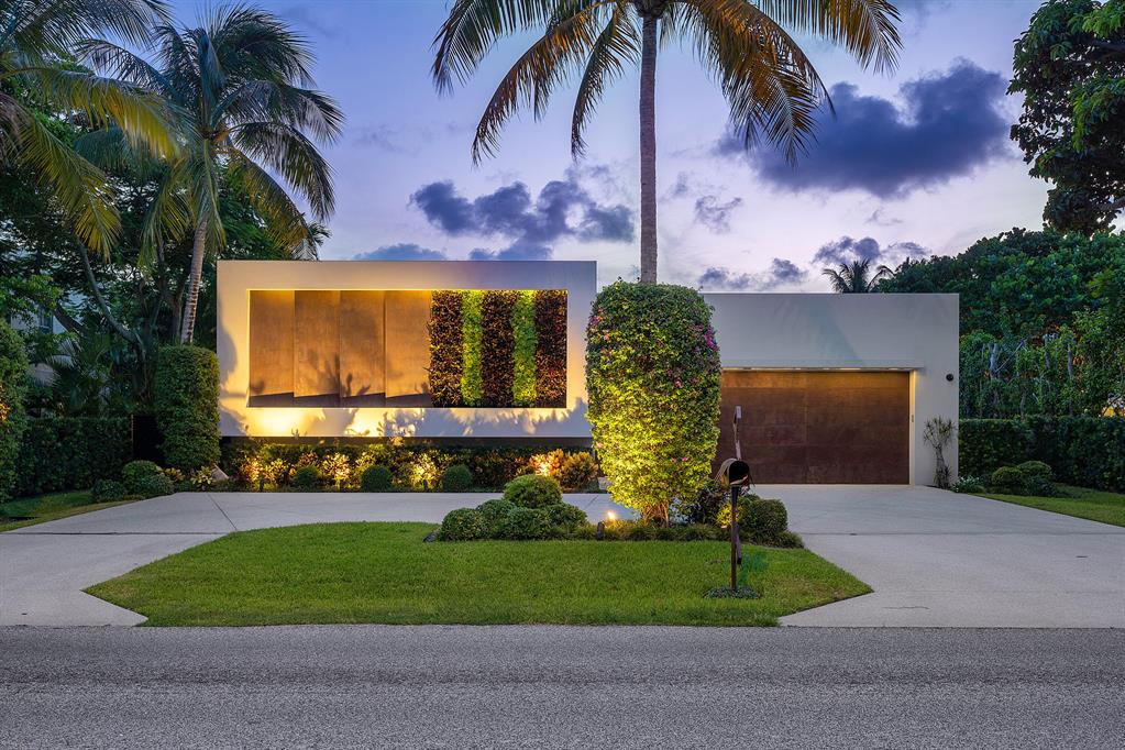 An architectural masterpiece in the heart of Delray Beach, 1106 N Swinton Avenue exudes a sense of modern zen that will leave its visitors in bliss. Designed by Richard Jones and built in 2020, every detail of this 4 bedroom, 4.1 bathroom residence has been expertly designed to cater to the modern living experience. First impressions are everything, and you'll be wowed by the living wall that pops out of the unique patinaed steel on its front facade and garage, which leads to the private world of the courtyard gardens and pool oasis.  Upon entry, you'll find that the patinaed steel continues inside the home's gallery, where inset lighting illuminates the home in a dramatic way.  Artistic form meets function in the home's wide open living space, where natural light pours through countless windows, bouncing off its large scale porcelain tiles and volume ceilings. Neutral tones and a wall of patinaed steel complement one another beautifully in the open kitchen and great room, where an oversized quartzite waterfall countertop begs to be the site where you and your closest friends and family share countless home cooked meals and cocktails.  
Waking up in the luxurious master suite each morning to verdant green that shimmers through floor to ceiling windows, you will have the choice of taking your morning shower inside or outside thanks to the seamless design of the master bathroom.  Just off the gallery are two other spacious bedrooms with ensuite bathrooms.  In addition, a detached fourth bedroom is the perfect place to imagine a private gym, office, or guest suite off the pool. 
The true focal point of this home, however, is its modern Balinese style outdoor courtyard. Floor to ceiling sliding glass doors from the master suite, great room, and detached guest suite lead the way to the lushly private outdoor space that features a heated plunge pool, summer kitchen, outdoor living room and fire pit. A great oak tree stands tall as the center point for the area, which twinkles at night with shimmering string lights. Your guests will never want to leave your tranquil private oasis. 
**Offered fully furnished excluding art, sculptures, and gym equipment.