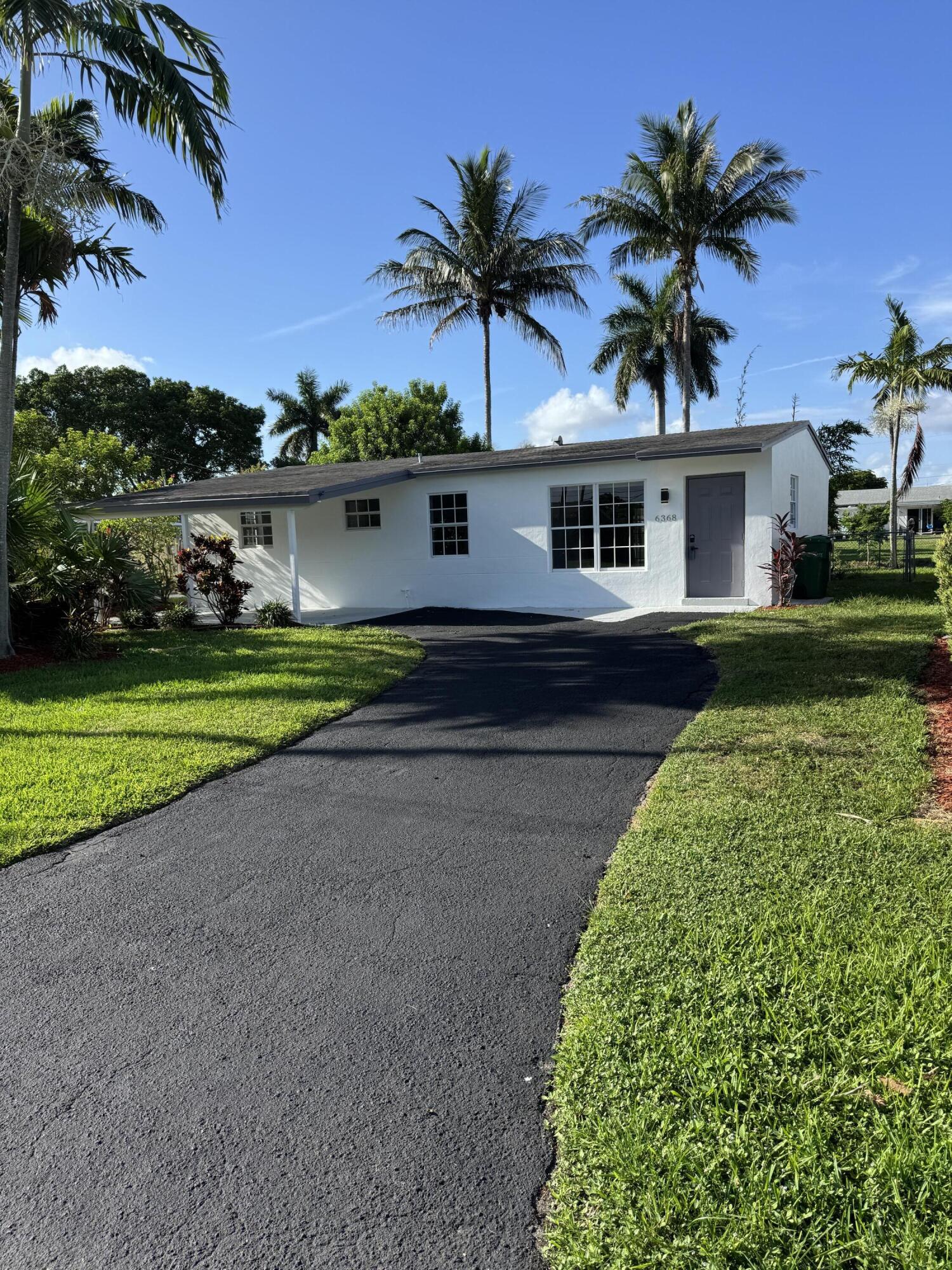 This 3 bedroom 2 bathroom house is on the water and features a large living room and dining area and new flooring throughout. The large kitchen has stove fridge and dish washer. We have a washer and dryer and a carport. There is a large screened in patio, large fenced and tropically landscaped back yard and much much more!!!!!. A must see!!! An amazing house in an amazing location!!!! Ready to move in. Located 15 minutes to Fort Lauderdale, 18 minutes to down town Ft. Lauderdale.  Don't miss this great opportunity.