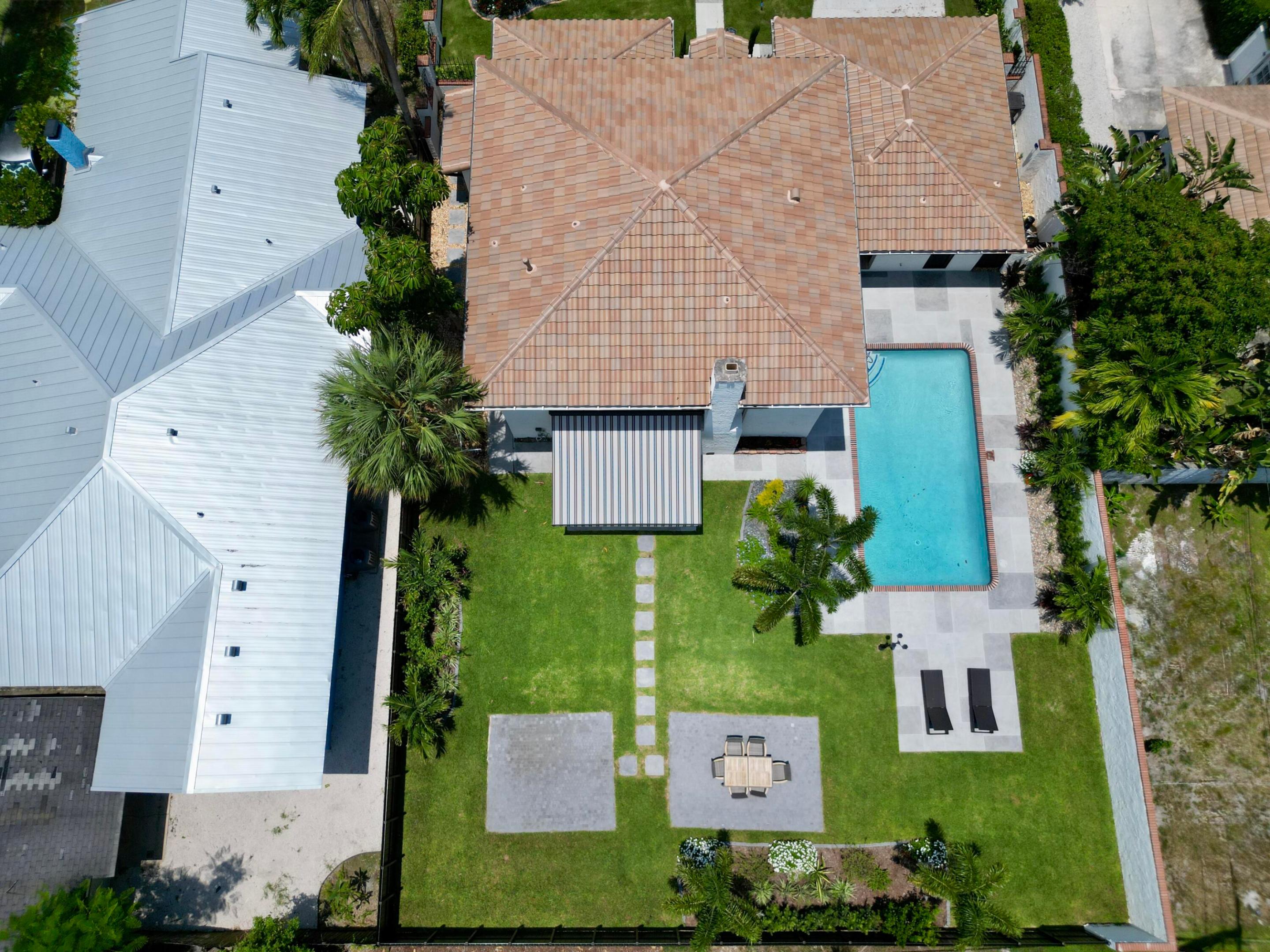 Rare Southland Park opportunity on an oversized 9,583 sq ft. fully fenced lot. This newly renovated 5BR/4.5BA home offers the charm and location buyers want near the Intracoastal and Downtown West Palm Beach, with ONE major advantage: home is not historically designated, giving future owners added flexibility to explore expansion or additions, subject to approvals. The home features impact windows and doors, updated all major systems, chef's kitchen with gas cooking, Taj Mahal quartz countertops, and a walk in wine cellar. The layout includes bedroom suites on both levels, offering first floor flexibility for guests, family, or multigenerational living, while the upstairs primary suite provides privacy. Pool, renovated, and rare lot size make this a move-in ready home with long term upside