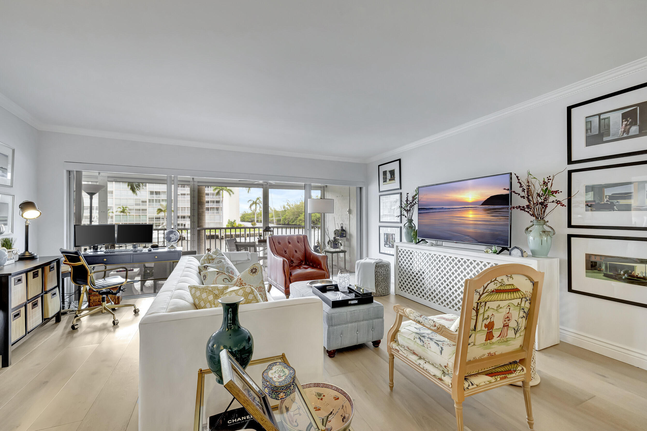 Enjoy tranquil water and marina views from your oversized screened in balcony, living room and primary bedroom. This unit has been redone to perfection with gorgeous, engineered hardwood flooring, all ceiling popcorn removed for a smooth finish, beautiful kitchen with light wood cabinetry, and stainless appliances. Washer and Dryer in unit. Affordable boat dockage when available. Walk across the street to the Cove plaza for great restaurants and shops and right over the bridge to beach and all that Deerfield beach has to offer! Fabulous designer furniture is negotiable. This is a must see!!