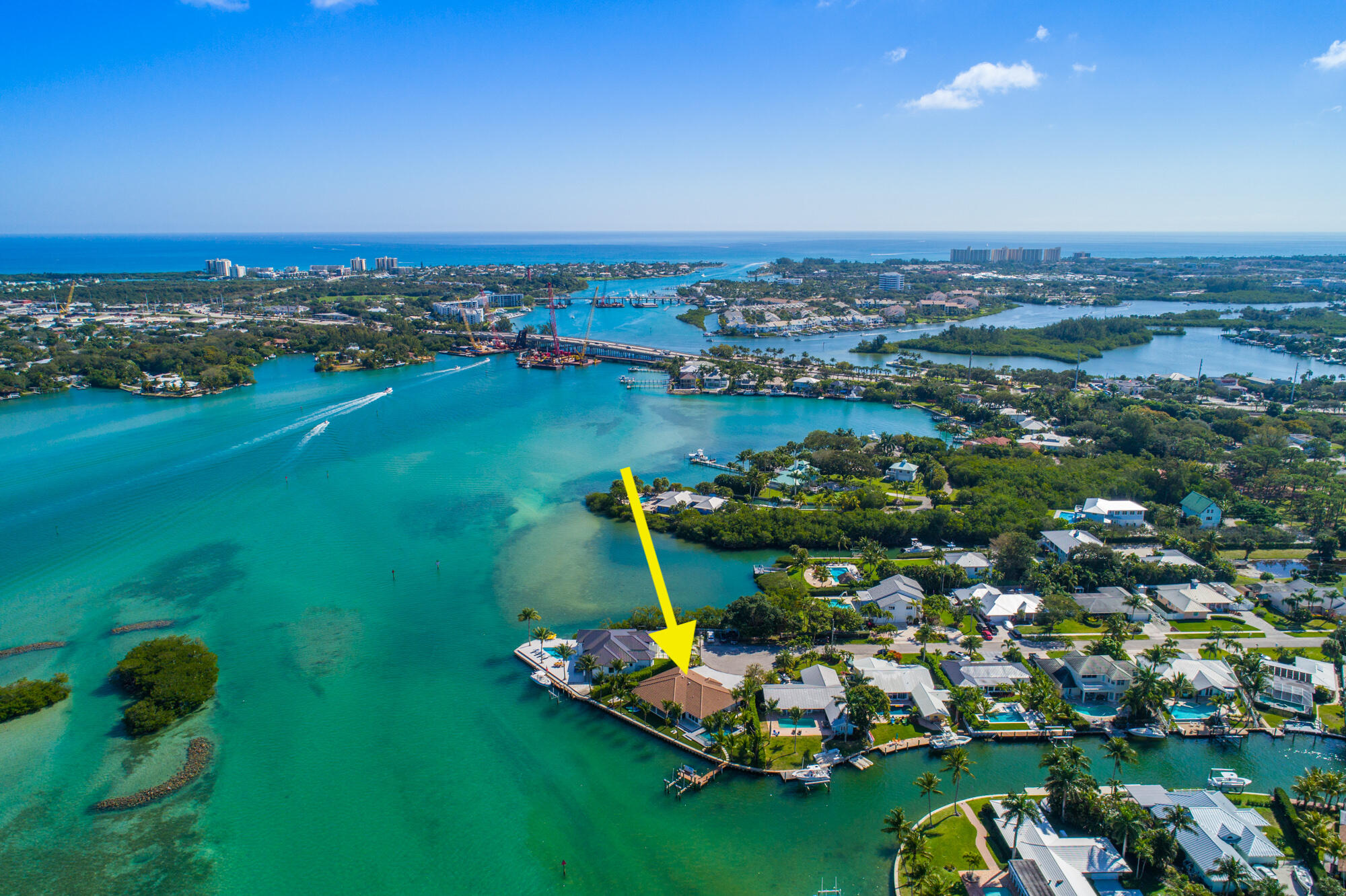 Rarely there comes an incredible opportunity of a lifetime, when something very special becomes available...this is it!  STUNNING, TURNKEY COASTAL MODERN MALIBU WATERFRONT POOL HOME situated on the 175' of BAHAMA BLUE WATER on the PREMIUM POINT LOT at the end of the cul-de-sac in the Heart of Jupiter. Unobstructed, panoramic views of the blue water along the Loxahatchee River from every room in this completely renovated 3 bed, 3 bath CBS single story pool home.  Designed with style, innovation and functionality, this house was reconstructed to the highest quality and no expense was spared.  It features open, split floor plan, 2 LIVING AREAS; with expensive barn doors separating areas; ceiling to wall impact glass doors/windows, custom LED lighting & stylish porcelain tile flooring. The HIGH QUALITY STATE OF THE ART ISLAND KITCHEN with soft close & inset custom built cabinets, quartz counters and commercial grade appliances.  The house features a spacious master suite, custom closets, smart house/home automation and so much more.  The tropical outdoor living areas include salt water heated pool w/sun ledge & bubbles, new 30,000 lb boat lift & heavy duty dock, water depth: low tide 4', high tide: 7.5', new concrete seawall, incredible fishing, tropical lush landscaping & expensive synthetic turf.  The house is located immediately adjacent to the Jupiter Inlet and the Bahama blue water, minutes to the ocean either by boat or car!