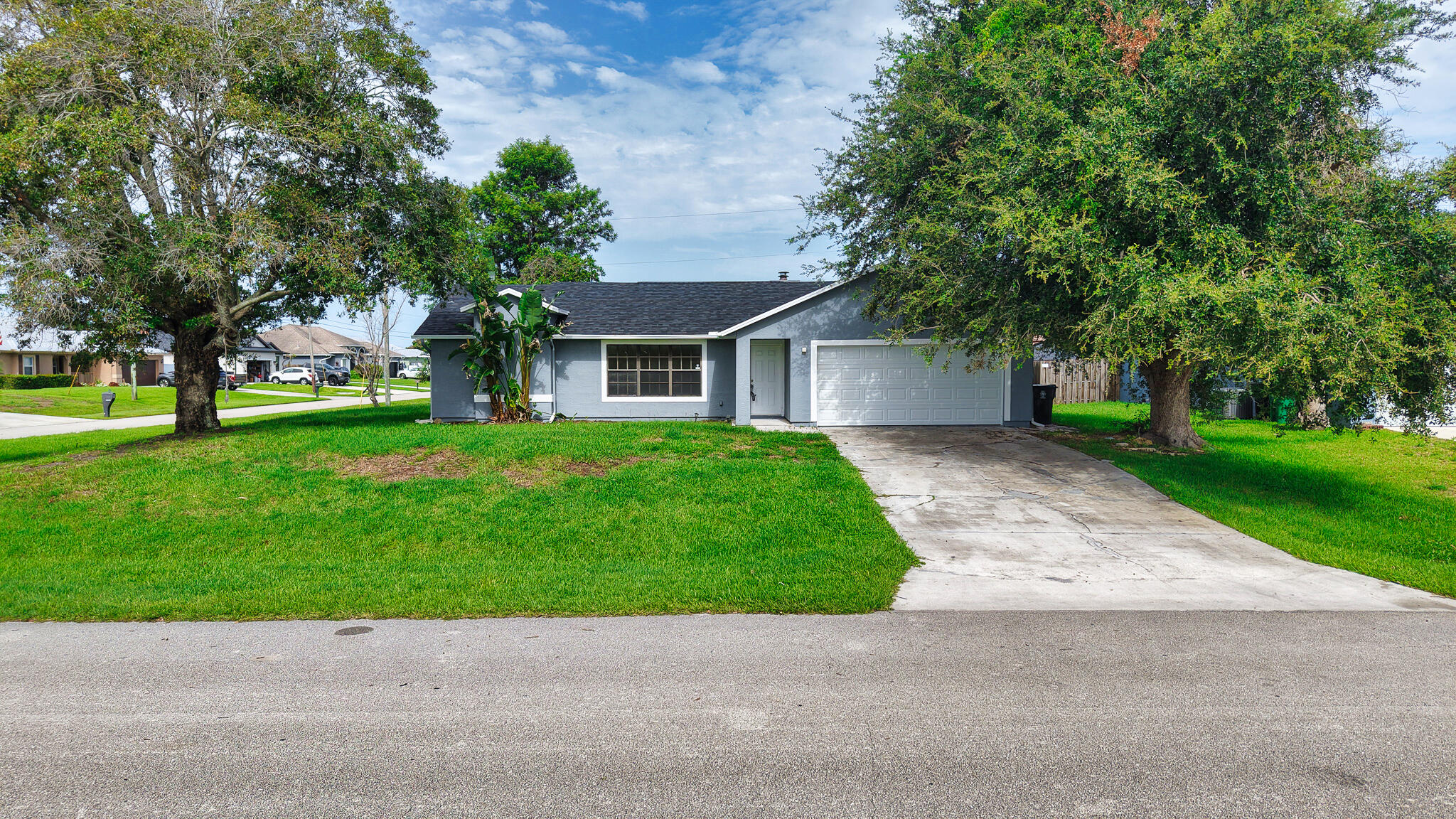 A 2026 roof, gorgeous quartz countertops in the kitchen, and waterfront views for only $325,000...this one is a stunner! This absolute cutie offers new stainless steel appliances, luxury vinyl flooring throughout the home, and a spacious pantry in the kitchen. All bedrooms are equipped with ceiling fans with lights, and the master suite boats an oversized walk in closet. Both the master and guest bathrooms have quartz vanities and a shower/tub combo. The family room adds character to the home with a wood burning fireplace, vaulted ceilings, and direct access to your private back patio (covered and screened). Additional amenities include: corner lot, gutters, stucco exterior, a formal dining room, security system, 2023 AC, garage door opener, and storm shutters.