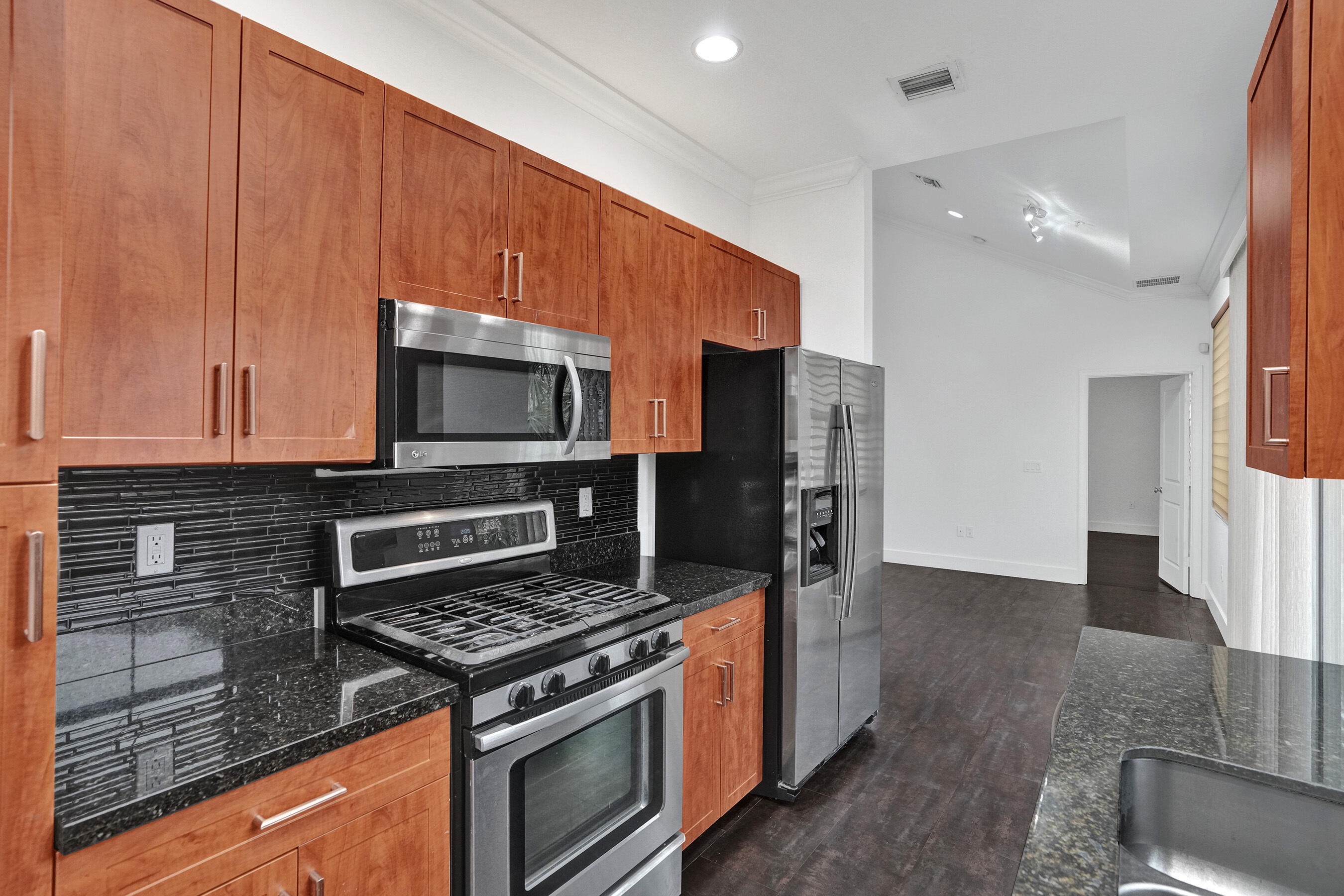 Experience luxury resort living in this marvelous, airy 2BR+Loft/2BA townhouse. Dramatic spiral stairs take you up to the spacious den / that can be used for a home office. Enjoy the beautiful luxurious blend of dark porcelain tile (living area), and bamboo wood flooring (bedrooms/stairways). The well-equipped kitchen boasts cherry cabinets, granite counter tops and a gorgeous marble back-splash. Impact windows throughout! Superb amenities such as tranquil pools, sports courts & gym will become part of your life! Walk to Sawgrass Mall & Amerant Bank Arena (Home of the Florida Panthers).