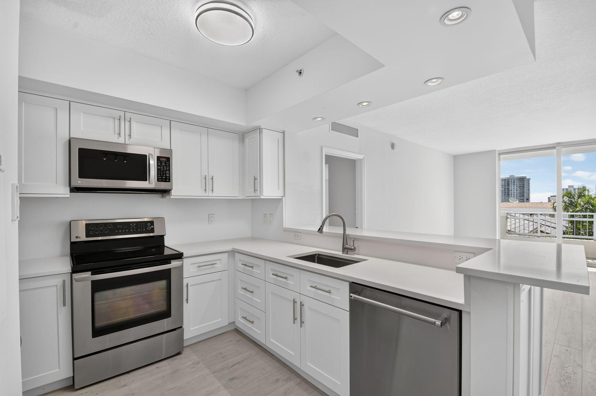 DOWNTOWN LIVING AT ITS BEST!  Beautiful 2 Bedroom, 2 Bathroom Residence featuring an extra-large 1,328 sq. ft. Split-bedroom floor plan. Desirable east-facing Private Balcony.  Enjoy the morning sun and expansive City Views. The newly renovated white kitchen features top-of-the-line stainless steel appliances and opens to the Spacious Living Room and Separate Dining Area. Beautiful wood-look laminate flooring flows throughout the residence. The oversized primary suite offers abundant closet space and a Luxurious Bathrooms with an oversized Soaking Tub, Separate Shower, Double Sinks, enhanced vanity, and upgraded countertops. The guest bathroom also features an updated vanity. Custom details, abundant storage, and a full-size washer and dryer complete this Exceptional residence. The Metropolitan is one of Downtown West Palm Beach's premier full-service luxury Boutique buildings, offering a spectacular rooftop pool and sun deck, fitness center, business center, elegant community room, 24/7 front desk attendant, assigned garage parking, and resort-style amenities.  Just steps to CityPlace, Fine dining, Shopping, Brightline, the Kravis Center. Minutes to Palm Beach Island, Worth Avenue, and the beach.  Luxury living in the heart of Downtown West Palm Beach.