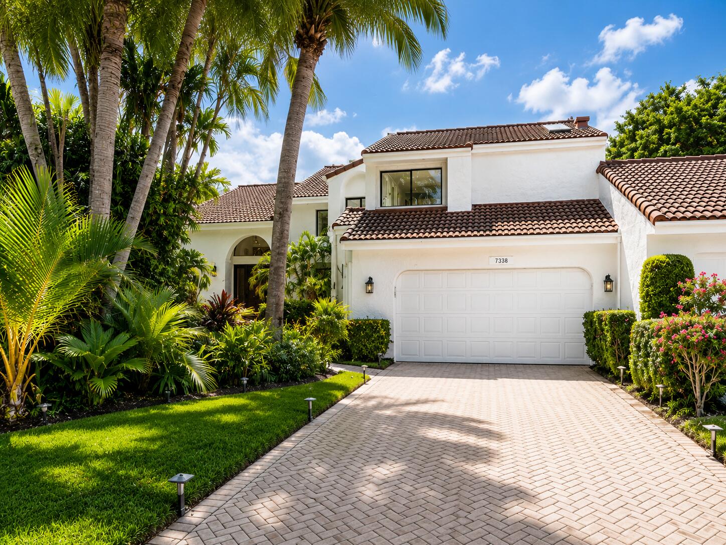 Rare opportunity to own a desirable townhome in Boca West's sought-after Woodcrest community. Located on a quiet cul-de-sac, this spacious residence offers features rarely found in Boca West, including a two-car garage, oversized driveway, and space for a golf cart. The inviting floor plan features a renovated primary bathroom and opens to a large screened patio overlooking a private backyard oasis with lush landscaping and a tranquil fountain—perfect for relaxing/entertaining. Enjoy year-round outdoor living in this peaceful setting. Boca West offers an unparalleled lifestyle with championship golf, tennis, pickleball, fitness, spa, dining, and endless social amenities. With the initiation fee about to increase, now is an excellent time to purchase in this premier private club community.