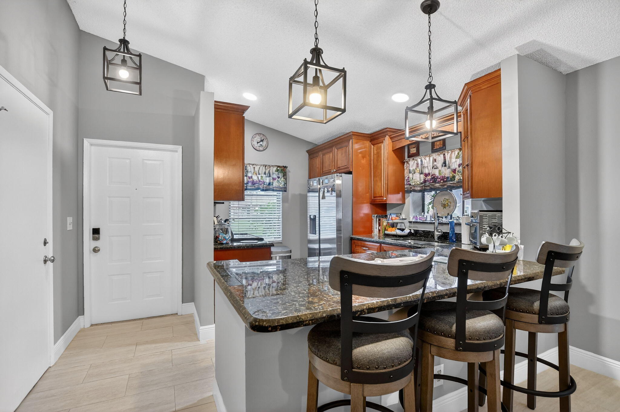 Experience Resort-Style Living! This meticulously 2-bed, 2-bath updated villa offers an open-concept design with a modern kitchen, granite counters, stainless steel appliances, and gleaming tile throughout. Freshly painted, new fixtures, and updated baths add to the appeal, plus a 1-car garage & 2-car driveway. Ready for someone to just bring their furniture and start to enjoy life in sought-after Whisper Walk! Whisper Walk is a gated community in a park-like setting with lush landscaping, lakes & tennis center including pickle ball, handball/paddleball & basketball courts, shows, events, exercise room, library, billiards, hot tub and heated pool. Internet,cable & water included in the quarterly maintenance
