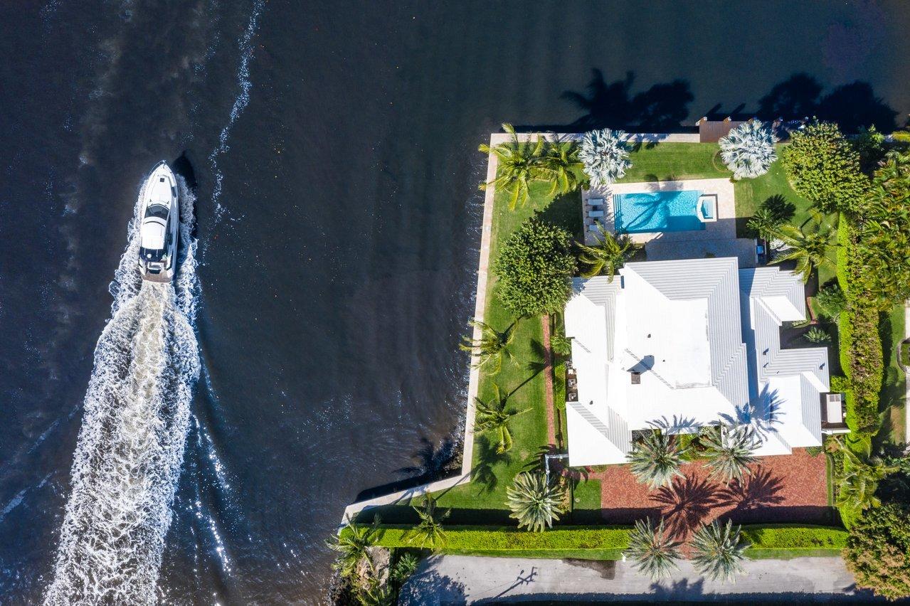 Staged against the sparkling intracoastal this 7,500 total square foot 5 bedroom 6.2 Bathroom Point Lot Estate is sited on an amazing 330 feet of water frontage. One of Gulf Stream's most desirable addresses 549 Golfview Drive commands wide water views from nearly every room. Articulating the ideals of classic design, the home features a gracious layout. Upon arrival, guests are greeted with a spacious foyer and sweeping staircase leading to a magnificent master suite with his and her bathrooms, large walk-in closets, a private balcony where owners can enjoy a peaceful respite and breathtaking sunsets all surrounded by water. Articulating the ideals of classic design using a diverse array of natural materials and textures the first floor encompass a lovely living room with floor to ceiling French doors, a fire place for the occasional cool evening, a grand dining room, spacious library with wet bar and peckey cypress ceilings a VIP guest suite plus two additional guest suites all with water views. An innovative kitchen with top shelf appliances features a custom designed island and a dining and relaxation zone that function as the social hub of the home. Impeccable craftsmanship, meticulous finishes and exquisite millwork are evident in every detail. Complementing the estate is a large loggia with outdoor kitchen and pool surrounded by an oasis of lush tropical landscaping bestowing supreme serenity with broad vistas reflecting the synergy of water and nature. Additional features include Santos mahogany and natural stone flooring throughout, Impact glass, phantoms screens, 3-car garage, full house generator, and a 40' dock with IPE decking. Just moments from the pristine sandy beaches, upscale shopping and restaurants, and many exciting diversions. Close to international airports for easy access. Your favorite part of going out will be coming home to your sumptuous home.