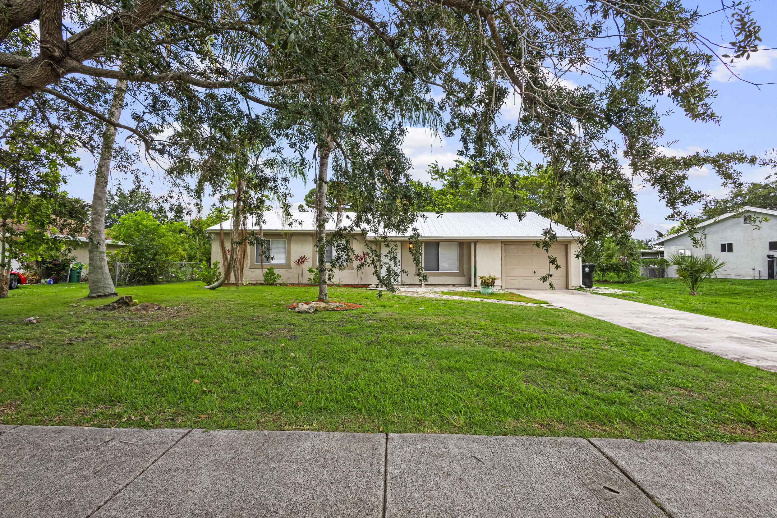 Welcome to this charming single-story residence in Port St. Lucie, offering over 1,600 square feet of comfortable living space. This three-bedroom, two-bathroom home provides practical floor plan design with a single-car garage. This beautifully renovated home features fresh modern updates throughout, this move-in-ready home offers a bright open floor plan with spacious living and dining areas, an updated kitchen, and stylish finishes.