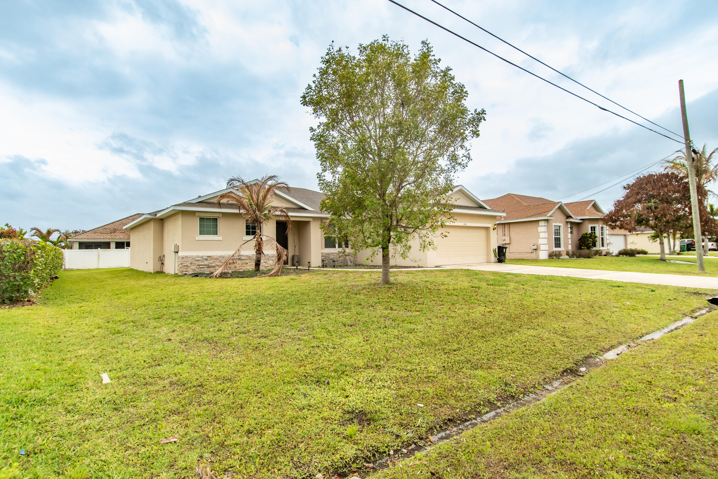 Welcome to this beautifully upgraded 3-bedroom, 2-bathroom home located in the heart of Port St. Lucie! This spacious residence features soaring high ceilings, 8-foot doors, and an open, airy layout designed for modern living.  The kitchen and bathrooms are finished with elegant granite countertops, complemented by 42" real wood cabinetry with crown molding, dovetail drawers, and soft-close doors offering both style and durability.   Enjoy generously sized bedrooms with walk-in closets, a 2-car garage, and a welcoming open porch perfect for relaxing or entertaining.  Conveniently located near shopping, dining, and major highways.