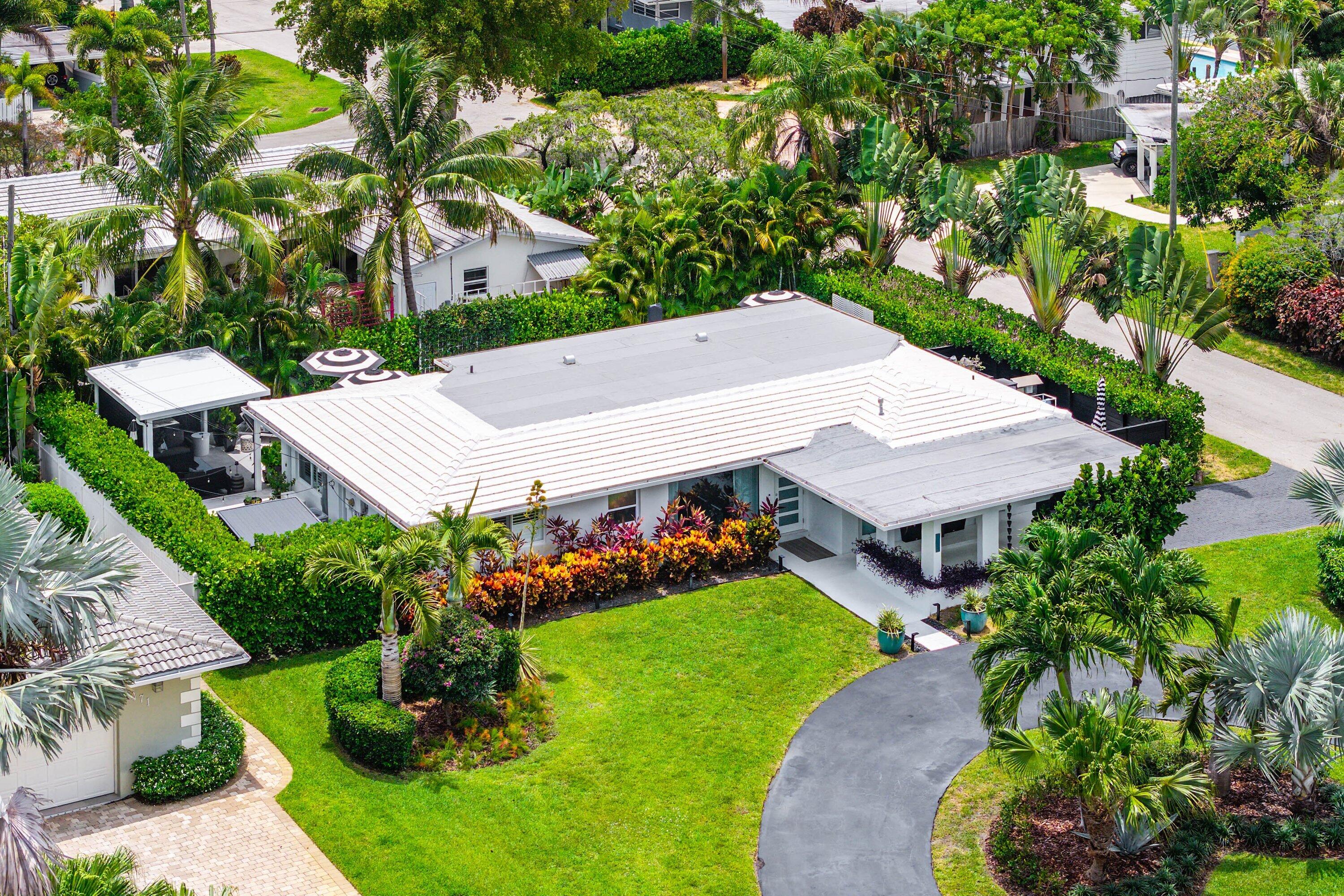 Completely remodeled and expanded 3-bedroom, 2-bath home with nearly 1,800 SF under air. The kitchen is built around a 13-foot quartz waterfall island, full Miele appliance suite, including double wall ovens and a full size wine refrigerator. Floor-to-ceiling windows flood the open living areas with natural light. Every finish, fixture, and system has been replaced, and the quality of the remodel is evident at every turn. Step outside to a heated saltwater pool with a cascading waterfall, attached spa, marble deck, full outdoor kitchen, and screened cabana that together create a genuine resort experience. Newer roof, impact windows/doors. Minutes from Wilton Drive, beaches, Las Olas Blvd, and the best of dining & shopping, and entertainment. No HOA.