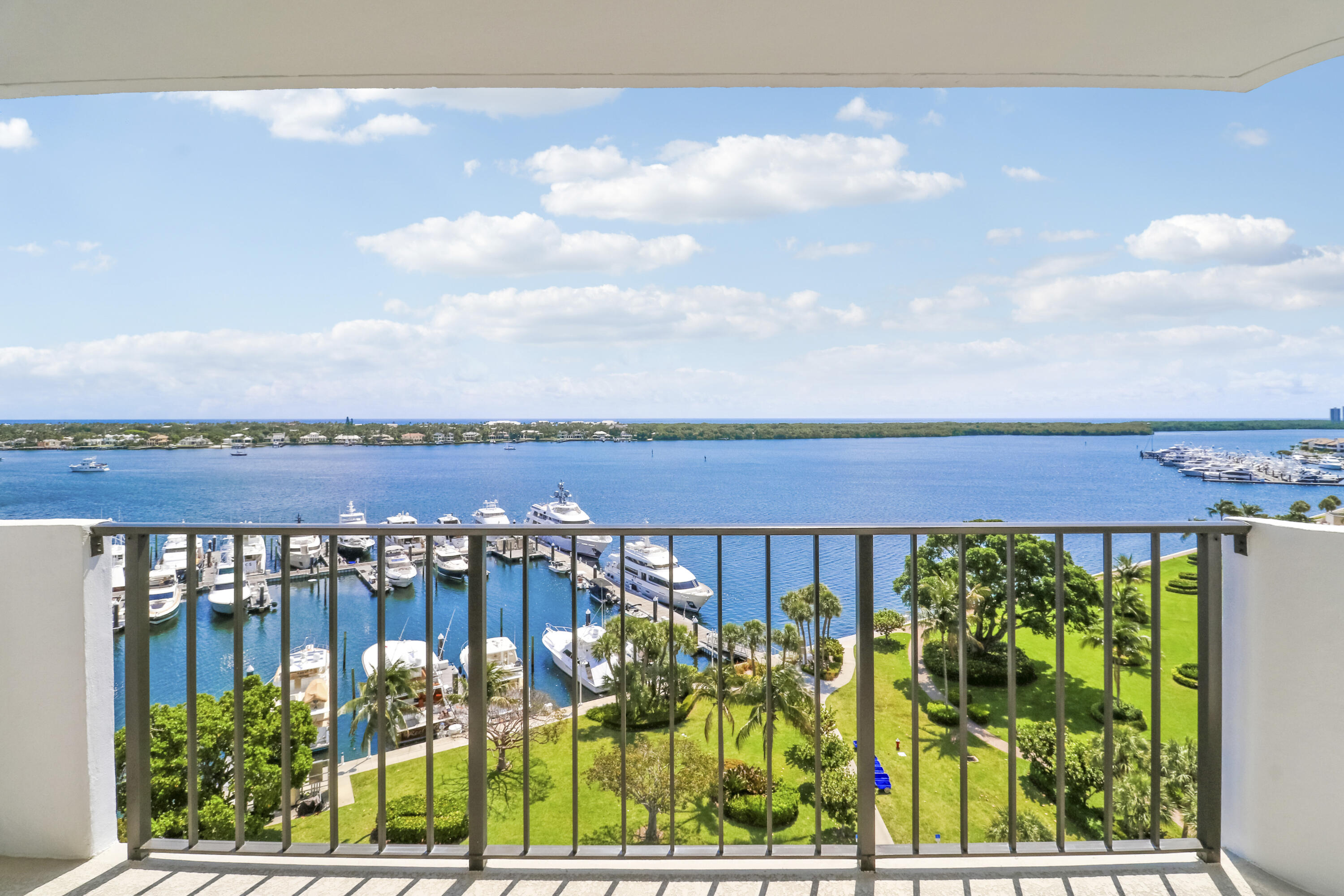 Rarely available, direct East facing condo with breathtaking views of the Atlantic Ocean, intercoastal waterway and the marina. Indulge in million-dollar views from every room at half the cost. The unit has been meticulously renovated from top to bottom using the highest quality appointments and a neutral color pallet. The kitchen boasts a breakfast bar, quartz countertops with full height backsplash, under cabinet lighting, brand new stainless appliances including an in-range air fryer, and space saving all in one washer / dryer. Spa like bathrooms with brushed gold finishes appeal to even the most discerning buyer. Brand new hurricane impact windows and doors. Under building, covered garage parking with premium assigned spot. Building amenities include pool, tennis courts, shuffleboard, loggia room for social events and a library. All of this, in the highly sought-after community of Old Port Cove, which covets a gatehouse with security, 2-mile waterfront walking trail, waterfront dining and cocktails at Belle's, the onsite restaurant and boat slips available through Safe Harbor Marina, all just steps from your front door.