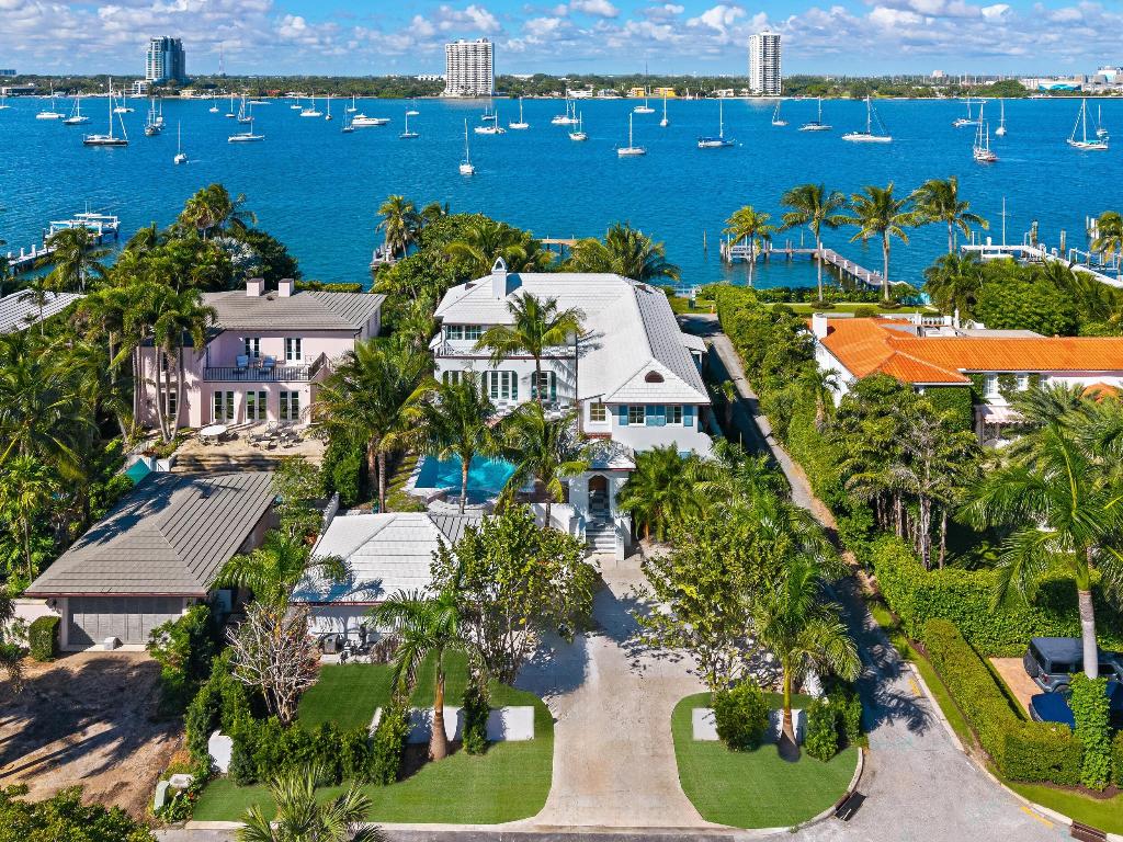 Spectacular Newly Completed Lakefront home with deep water dock and access to the Lake Trail. With spectacular views of the Intracoastal, this stunning home has been beautifully restored and features 5 bedrooms, 7 bathrooms, 1 powder room, and over 6,800 total square feet. Fabulous courtyard pool area perfect for outdoor entertaining with covered loggia, expansive patio, salt-water pool, and spa. Interior highlights include formal dining room, fabulous eat-in kitchen, media room, and den. Beautiful Primary Suite with dressing room, large bath with dual sinks, and breathtaking views. Additional features include lush tropical landscaping, 2-car garage, multiple balconies, and charming entry portico.