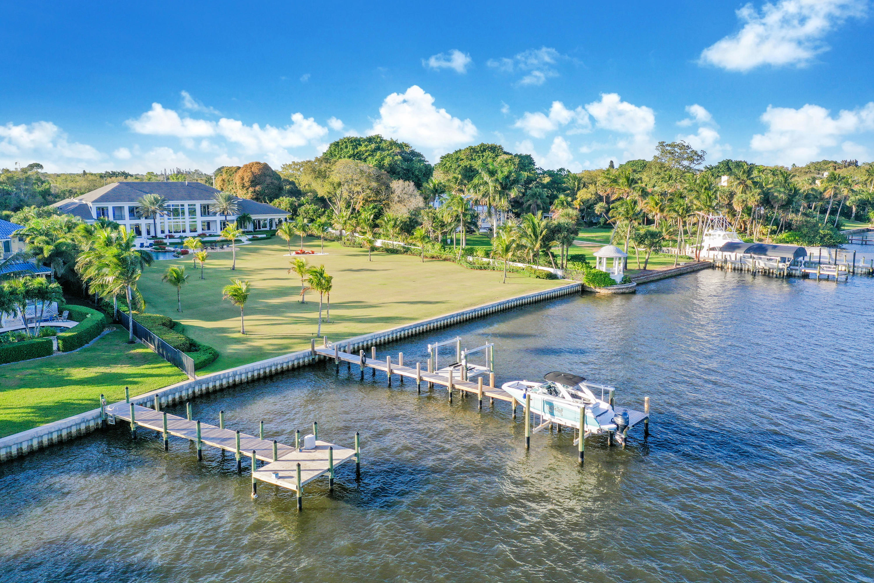 This magnificent St. Lucie River estate rests  majestically on 2.4 Acres. This spectacular 5BR home was designed, custom built and finished in 2017 with the utmost attention to function, flow and fun. 205 ft. NEW seawall and 60ft. dock w/lifts. Panoramic views of the River, Intracoastal and Inlet from outdoor entertaining areas and most indoor rooms.  Seamless, elegant plan is complemented by Fitness and Trackman simulator room, his and her offices, Pub with 1144 bottle wine cellar, custom kitchen with superior grade appliances and 5-bedroom suites. Spacious rooms flow impeccably with beautiful limestone and French oak floors. At times it can be difficult to enjoy the exquisite interior when the spacious outdoor kitchen and loggia welcome you to lagoon waterfall pool, firepit and tiki hut. So much more.... New seawall and deep-water dock adorn 205 feet of riverfront. A/C 4 car garage with bonus room above. Deep water dock has power, water and 2  12,500 LB lifts, 48 KW Generac powers full house, top of the line appliances, game room/sports room for Masters, Super Bowl and so many special events.