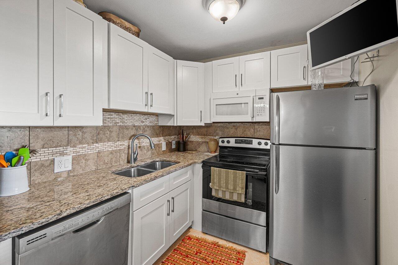 Welcome to this inviting fully renovated one-bedroom, one-bathroom condominium located in Suffolk at Century Village in Boca Raton. Features include an updated kitchen with granite counters and stainless steel appliances. Brand New AC and blinds just installed and a new Hot Water Heater as well! This efficient 600-square-foot first floor residence offers comfortable living in the beautiful Boca Raton. The thoughtfully designed layout maximizes the usable space, making it an excellent choice for those seeking a manageable home in a well-established community. Situated in the heart of Boca Raton, this condo presents an opportunity to enjoy convenient Florida living in Century Village.  This 55+ active adult community offers a fabulous club house, indoor and outdoor pools, tennis and pickleball, bus transportation and of course entertainment and additional resort style amenities. Priced to sell! The lowest priced first floor unit in all of Century Village!