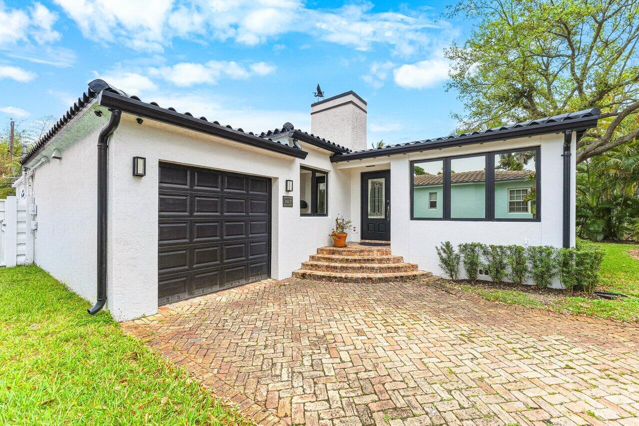 Step into refined living in this impeccably upgraded two bedroom, three bath home with a versatile den, easily convertible to a third bedroom. Ideally located near a serene park, it features impact windows, sleek curb appeal, a designer driveway for four cars, and a one-car garage.  The showpiece is the brand-new 2025 kitchen, thoughtfully designed with white shaker cabinetry, quartz countertops, an oversized island, matte black finishes, a chef's gas range, and premium stainless appliances, all within a bright open-concept layout complemented by rich hardwood floors.  Enjoy a private backyard oasis with a pool and covered lounge. No HOA offers ultimate freedom, flexibility, and investment potential. Located in the heart of Hollywood, close to parks and beautiful beaches.