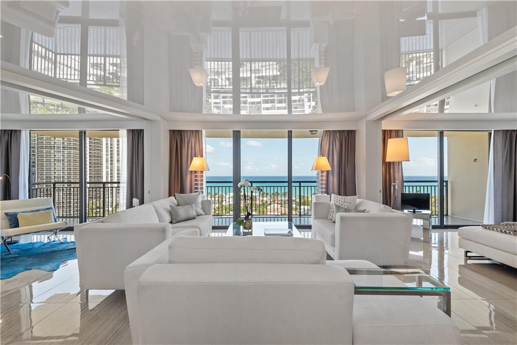 Stunning renovation. Spectacular Ocean views. This unit was completely re-designed and reconstructed with a dazzling modern flare and no expense spared. It includes beautiful porcelain floors, a dramatic white reflective ceiling, hurricane impact windows, and a 330 sq. ft. terrace accessible from the living room and both bedrooms. The kitchen has quartz counters, a stacked stone backsplash, sleek white cabinetry, stainless steel appliances and a convenient breakfast bar. The adjacent dining area allows for beautiful views of the ocean and floor to ceiling windows. The primary bedroom suite has a walk-in closet and stunning bath. The guest room includes a Murphy bed. Plus, location, location, location! Only a 5 minute walk to the beach makes this the perfect Winter get away.