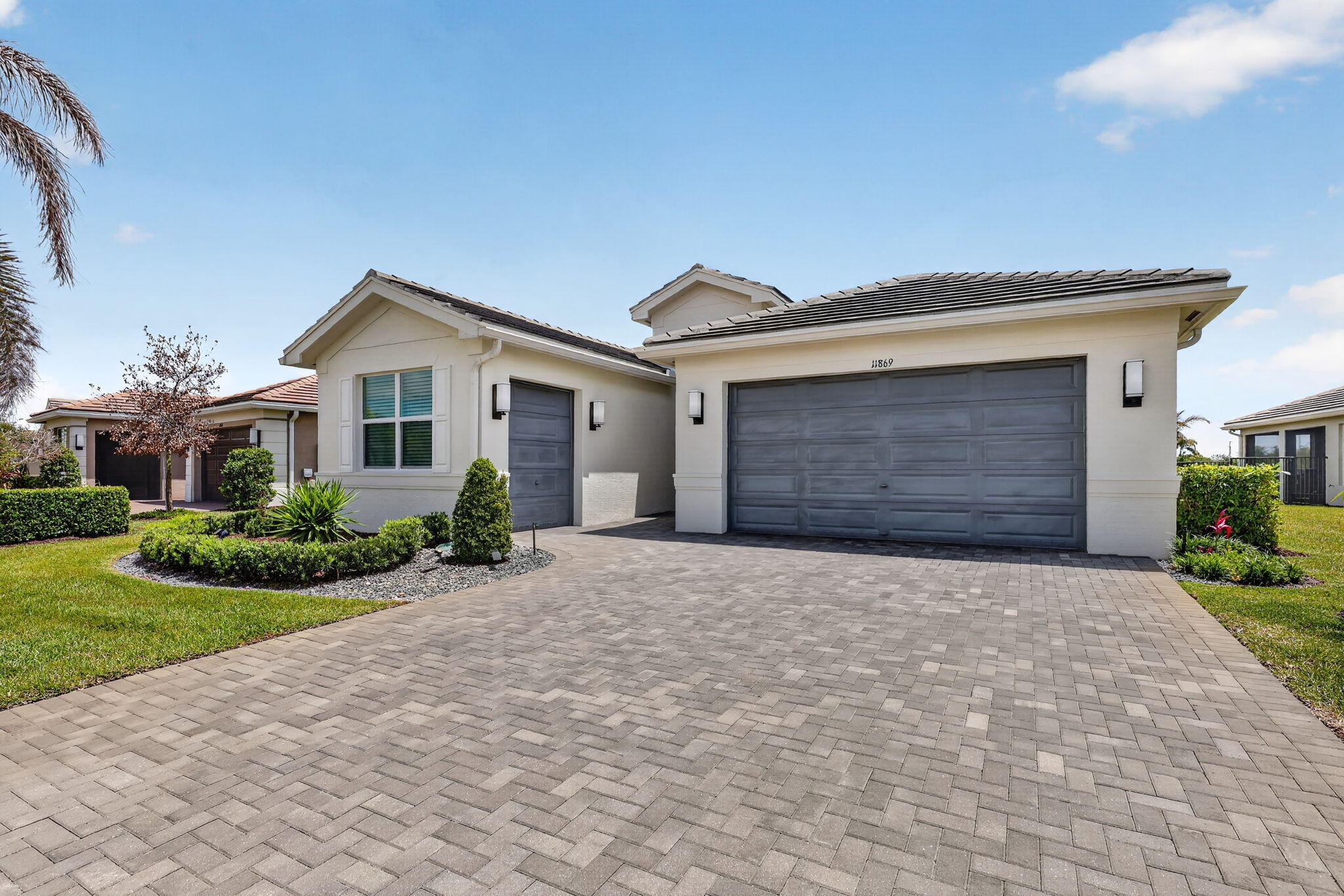 FOR SALE in GL Homes' 55+ Valencia Grove at Riverland, in Port Saint Lucie, FL Skip the wait, uncertainty, and expense of new construction. This beautifully upgraded Atlantica model in Valencia Grove at Riverland is ready to enjoy today, offering a premium water view, an east-facing patio for spectacular sunrises, and thousands of dollars in upgrades already completed for you. Designed for effortless Florida living, this 2,167-square-foot home features a bright open-concept floor plan with two bedrooms, a versatile den that can serve as a third bedroom, 2.5 bathrooms, and a two-car garage. Elegant 32" x 32" rectified porcelain tile flows throughout the home, creating a seamless, sophisticated look with no carpet to maintain. The upgraded kitchen serves as the centerpiece of the home,   featuring Level VI cabinetry with crown molding, quartz countertops, a custom pantry, Samsung refrigerator and dishwasher, GE slide-in range and microwave, and an open layout that connects beautifully to the living and dining areas for everyday enjoyment and entertaining. The primary suite is relaxing and beautiful featuring built-out closets, floor-to-ceiling tiles, a frameless glass shower enclosure, dual sinks, custom cabinetry, and thoughtful storage upgrades.  Throughout the home, you'll find high-end enhancements including zebra shades with motorized treatments in key living areas (the den and guest room open manually), a custom fireplace feature wall designed for a 75" TV, upgraded lighting and electrical features, and a whole-house Apec water filtration system with reverse osmosis in the kitchen. The exterior is just as impressive, featuring a widened driveway and walkway, impact glass front entry door, full-house gutters, and a 2-car garage plus a separate golf cart garage finished with Swiss Trak flooring. A Napoleon BBQ grill with rotisserie adds to the outdoor lifestyle, all set against peaceful water views. Valencia Grove residents enjoy access to a 34,000 sq. ft. clubhouse with resort-style pool, fitness center, full-service restaurant and bar, social clubs, and year-round activities. Riverland also offers a 16-acre Sports & Racquet Club, a 5-acre Arts & Culture Center, and scenic walking and biking trails along the Riverland Paseo.  Ideally located just minutes from Tradition, the Cleveland Clinic Hospital, shopping, high-end and casual dining, and Clover Park, home of the New York Mets spring training. A full-size Costco is scheduled to open in 2027 within a 10-to-15-minute drive from Riverland.