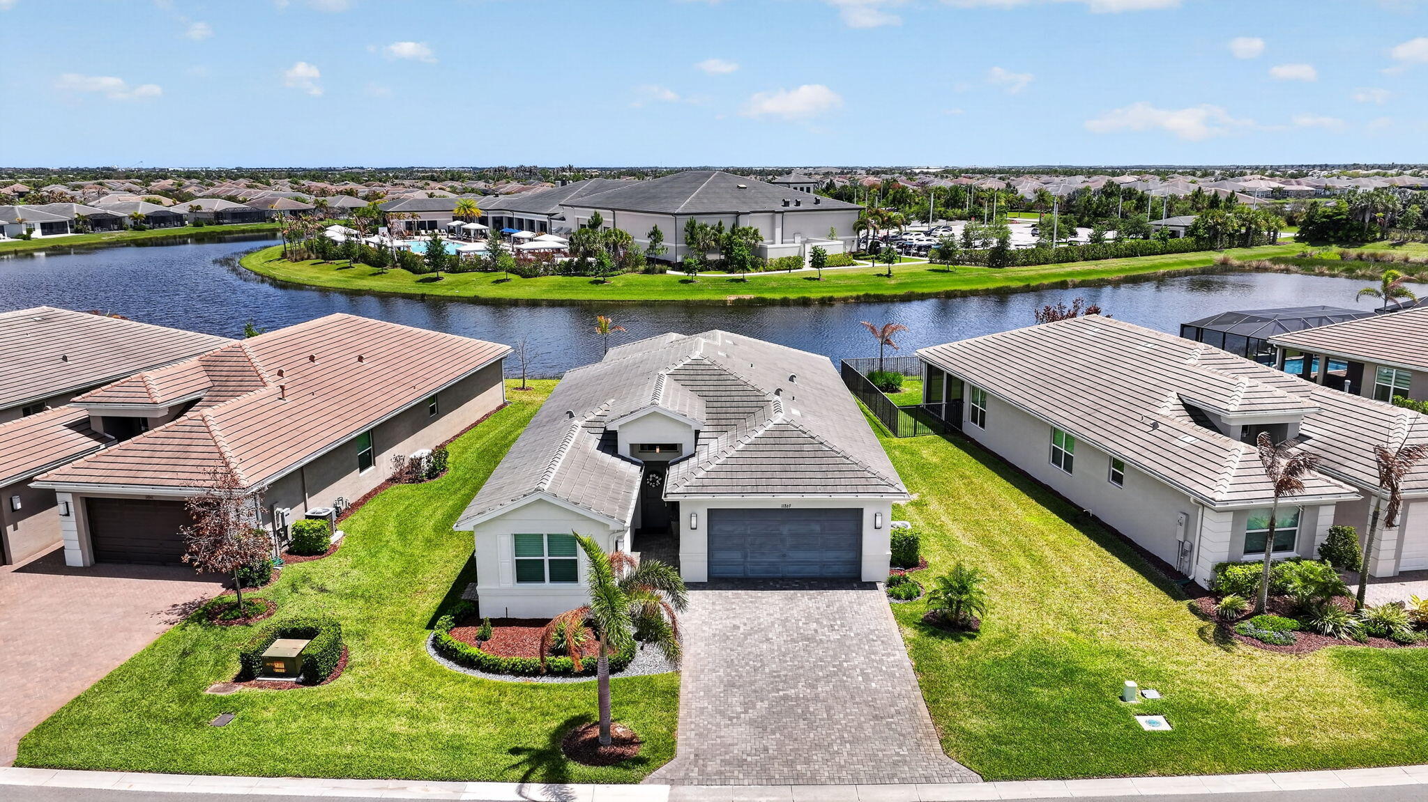 FOR SALE in GL Homes' 55+ Valencia Grove at Riverland, in Port Saint Lucie, FL Skip the wait, uncertainty, and expense of new construction. This beautifully upgraded Atlantica model in Valencia Grove at Riverland is ready to enjoy today, offering a premium water view, an east-facing patio for spectacular sunrises, and thousands of dollars in upgrades already completed for you. Designed for effortless Florida living, this 2,167-square-foot home features a bright open-concept floor plan with two bedrooms, a versatile den that can serve as a third bedroom, 2.5 bathrooms, and a two-car garage. Elegant 32" x 32" rectified porcelain tile flows throughout the home, creating a seamless, sophisticated look with no carpet to maintain. The upgraded kitchen serves as the centerpiece of the home,   featuring Level VI cabinetry with crown molding, quartz countertops, a custom pantry, Samsung refrigerator and dishwasher, GE slide-in range and microwave, and an open layout that connects beautifully to the living and dining areas for everyday enjoyment and entertaining. The primary suite is relaxing and beautiful featuring built-out closets, floor-to-ceiling tiles, a frameless glass shower enclosure, dual sinks, custom cabinetry, and thoughtful storage upgrades.  Throughout the home, you'll find high-end enhancements including zebra shades with motorized treatments in key living areas (the den and guest room open manually), a custom fireplace feature wall designed for a 75" TV, upgraded lighting and electrical features, and a whole-house Apec water filtration system with reverse osmosis in the kitchen. The exterior is just as impressive, featuring a widened driveway and walkway, impact glass front entry door, full-house gutters, and a 2-car garage plus a separate golf cart garage finished with Swiss Trak flooring. A Napoleon BBQ grill with rotisserie adds to the outdoor lifestyle, all set against peaceful water views. Valencia Grove residents enjoy access to a 34,000 sq. ft. clubhouse with resort-style pool, fitness center, full-service restaurant and bar, social clubs, and year-round activities. Riverland also offers a 16-acre Sports & Racquet Club, a 5-acre Arts & Culture Center, and scenic walking and biking trails along the Riverland Paseo.  Ideally located just minutes from Tradition, the Cleveland Clinic Hospital, shopping, high-end and casual dining, and Clover Park, home of the New York Mets spring training. A full-size Costco is scheduled to open in 2027 within a 10-to-15-minute drive from Riverland.