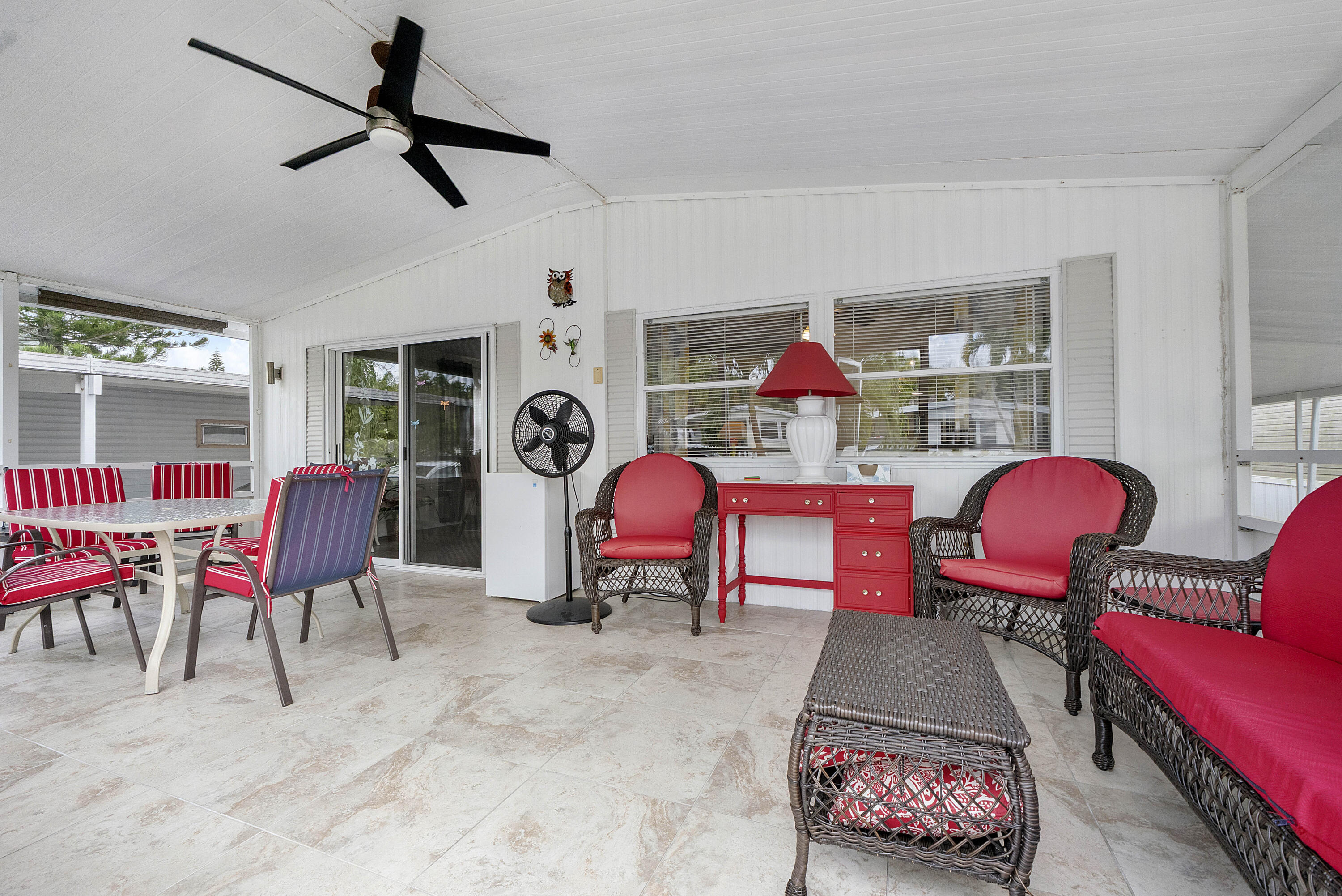 Spacious and well-maintained double-wide manufactured home where you own the land, located in a desirable all-ages community. Enjoy a large screened Florida room at the front—perfect for relaxing and entertaining. This home features a new A/C (2025) and an electrical panel replaced a few years ago. Large shed with additional fridge, plus washer and dryer for extra storage. Nice backyard with hurricane shutters on the side and back of the home.   Community with a lot of amenities including an Olympic-size swimming pool, sauna, gym, bowling alley, tennis, pickleball and more! Conveniently close to shopping, the Hard Rock Casino, great restaurants, and just a few miles from the beach. Very low maintenance fees!