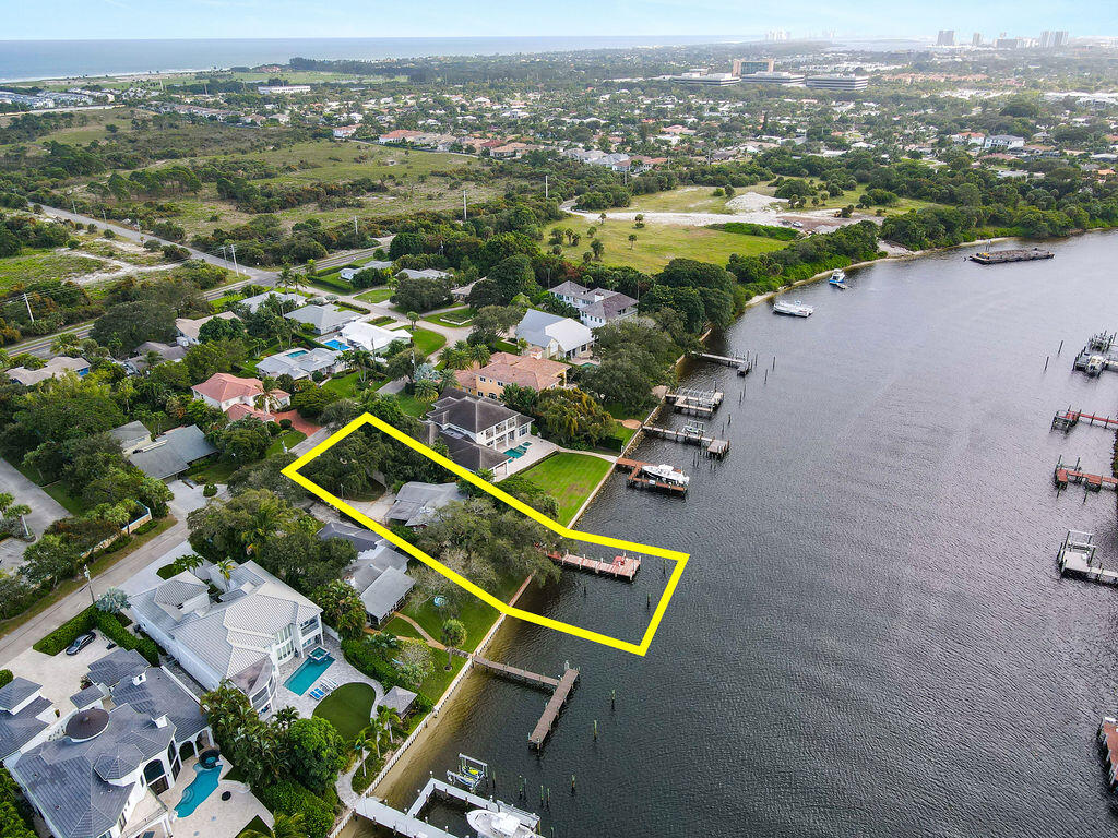 Oversized Intracoastal lot with dock, ideal for building a waterfront estate and living the ultimate Florida lifestyle of which dreams are made. Conveniently located on the Palm Beach Intracoastal Waterway with views of the boats going by. A 50' dock is included with a 5' water depth. Rarely available amount of waterfront land with plenty of mature trees and greenery, great for entertaining all of your outdoor activities and providing shade and ambiance. Perfect for boaters with access to deep water and no fixed bridges. Currently occupied with a charming 3 bedroom bungalow that could be a residence until building commences. Rolling Green and the surrounding area is a highly sought-after prime location, surrounded with gorgeous multi-million dollar properties at every turn. There is no HOA, allowing this property's potential to be designed by you to your ideal specifications. Perfectly situated near boating amenities, fine dining, shopping, Jupiter & Juno beaches and mere minutes by boat to waterfront dining and the inlet.