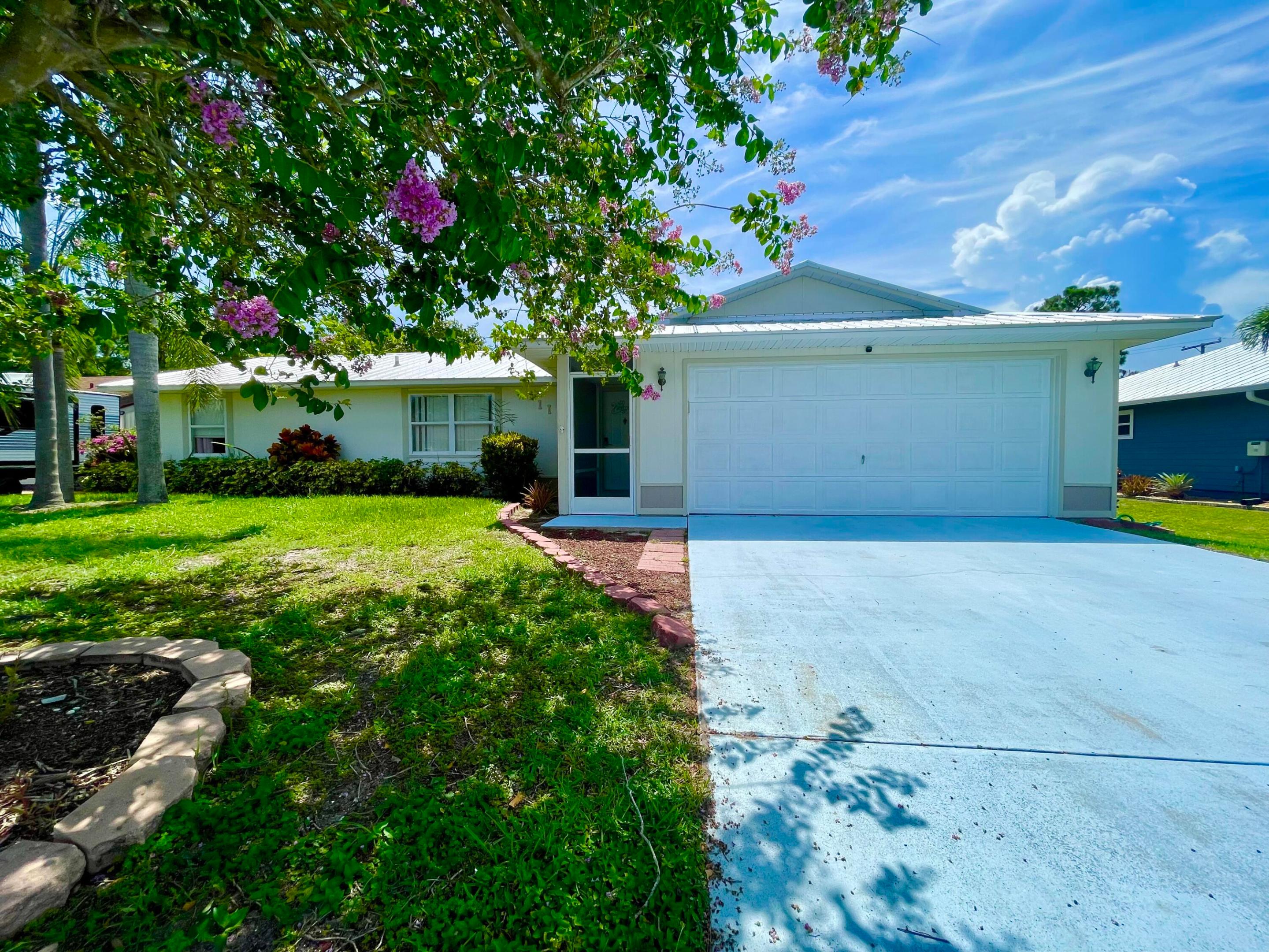 The total Square Feet: 2,618, including livable and non-livable areas such as lanai, porch, and garage. Lot size: 10,000 sq ft. This beautiful POOL home features 3 Beds/2 full Baths/2-car attached garage with an open split-bedroom floor plan and walk-in closets. No HOA or restrictions! The interior is updated with vinyl plank flooring (2021), a newer A/C (2020), water heater (2022), and electric panel (2021). It also boasts a new METAL ROOF (2021), washer/dryer (2021), New stove (2026) and pool filter/heater (2021). Step outside to a fully screened-in pool area and a fenced backyard with lush landscaping for privacy—ideal for pets, play, or unwinding. Plus, enjoy your own mango tree! **This property was previously an Airbnb so it's great for investors for an extra income**