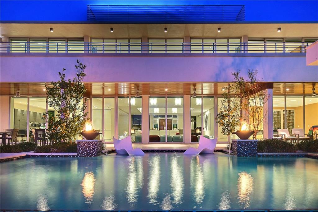 The ultimate Modern architecture, both sophisticated & expansive, 100ft of waterfrontage & perfect outdoor/indoor entertaining flow! Immediately dramatic open living & dining room adjoins incredible Chef's kitchen & family room.Waterfront views command entire residence. Custom pool is central focus with pavilion & summer kitchen. Club room, den, theatre,gym & wine room are on the 1st Level. 5 spacious bedroom suites + incredible Master Suite.Roof top terrace captures unbelievable views.Partially furnished