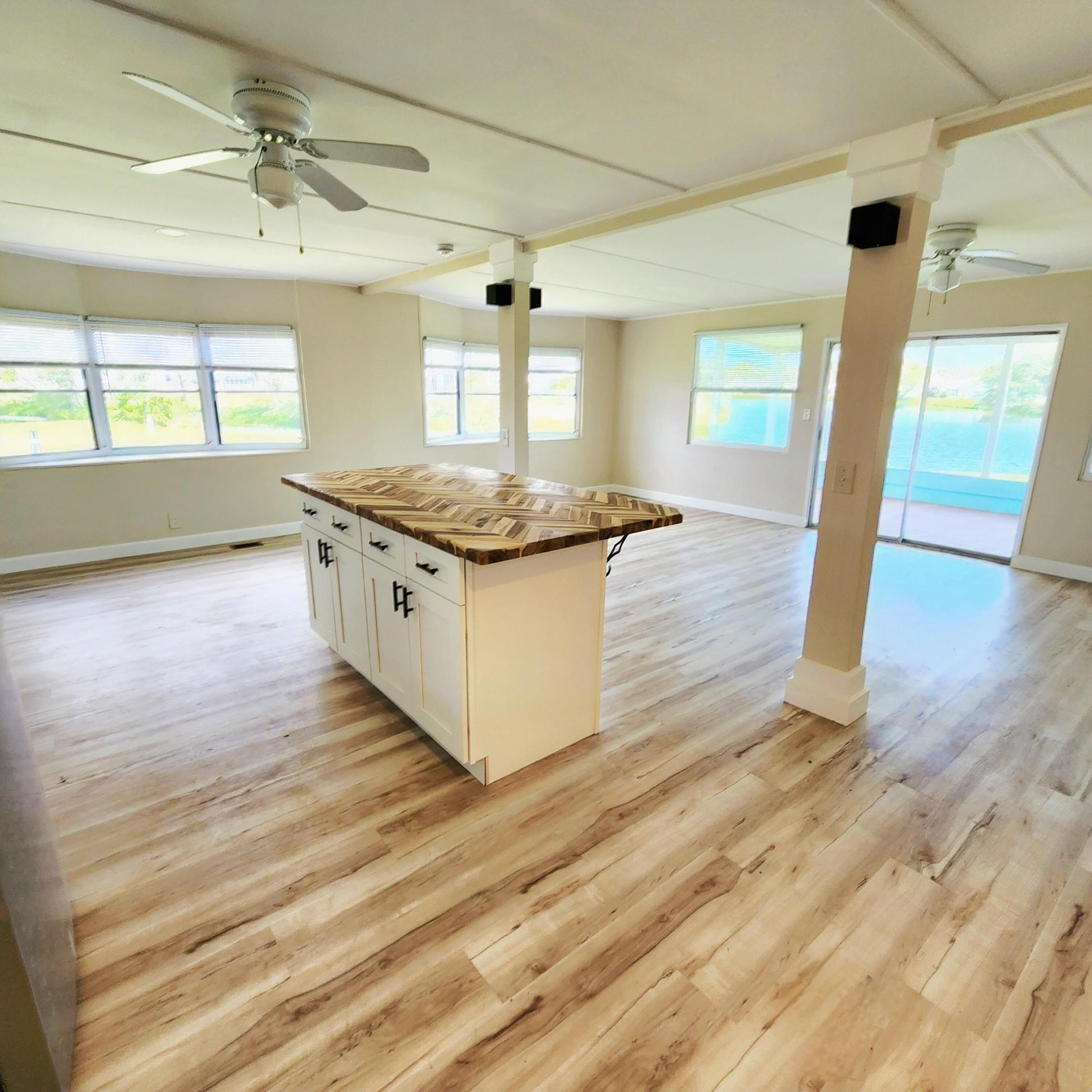 Beauty & tranquility surround this 2bed/2bath home, nestled in back of a Lrg corner lot w/ Panoramic Lake Views. Watch wildlife & sunsets on this Expansive lot offering Privacy & Space -great for pets, gardening, grilling, entertaining& more! Step inside & beauty continues - fully remodeled Open Concept. Recent Updates; New Roofing, Flooring, Screens, Windows, Renovated Kitchen w/ SS Appli., 5 ft Island, LARGE Bathrooms w/ DuraRock Showers &MarbleTops. Bedrooms w/ views! Master also boasts en-suite w/ walk-in closet. PRIMELOCATION; near Beach,Grocery,Postal,Banks,Hospitals, Pharmacy &more! LotRent of 992.53 incl LawnCare,Trash,Private FreeGolf, HeatedPool, Fitness,Pickleball,Tennis,Shuffleboard,Bocce,Gym,Library,Cards, MahJong,Biblestudy,WoodWorkshop,Parades,Dinners,Dances, trips & more!