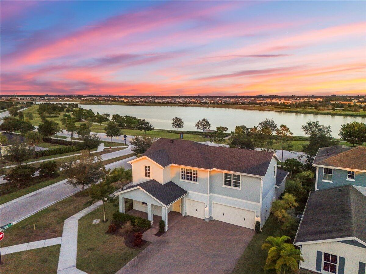 APPRAISED AT $785,000 (see MLS). STARTING BID $630,000. First showings SAT June 13th, 2026. Reserve your spot today!   Built in 2022. Rare waterfront corner lot with stunning lake views from the kitchen, living room, and primary suite (plenty of room for a pool and outdoor kitchen). This gorgeous Holly Model offers 5 bedrooms (with room for a 6th), 3.5 bathrooms (all new floors, upgraded kitchen with gas stove, garage with epoxy), and sits in Arden, one of Palm Beach County's newest family-friendly communities.  Enjoy breathtaking sunrise-to-sunset water views, direct access to the walking trail, and an oversized lot ready for your dream pool, outdoor kitchen, or custom playground. Use existing interior design plans or create your own masterpiece.