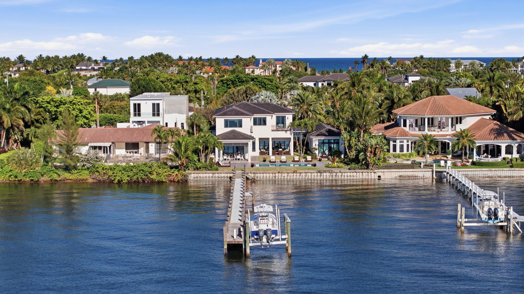 Welcome to an exceptional direct Intracoastal estate on exclusive Hypoluxo Island, masterfully built by renowned Hamptons builder Joseph Farrell. Showcasing timeless craftsmanship and effortless coastal sophistication, this five-bedroom, five-and-one-half-bath residence offers the perfect balance of luxury, comfort, and South Florida lifestyle.    Perfectly positioned on 100 feet of west-facing Intracoastal frontage, the property captures breathtaking sunset views and provides private dockage for a large vessel with convenient access to the ocean. The home's elegant interior is introduced by a dramatic two-story foyer and features expansive living spaces, oversized impact glass windows, elevated designer finishes, a state-of-the-art gourmet kitchen, and a desirable first-floor primary  suite designed for both privacy and convenience.    Outdoor living is equally spectacular, with an expansive entertaining terrace, summer kitchen, heated resort-style pool, and multiple spaces designed to maximize the extraordinary waterfront setting. Located just minutes from Eau Palm Beach Resort & Spa, Palm Beach, and the finest dining, shopping, and coastal amenities, this residence offers a rare opportunity to experience luxury waterfront living in one of Palm Beach County's most exclusive island communities.