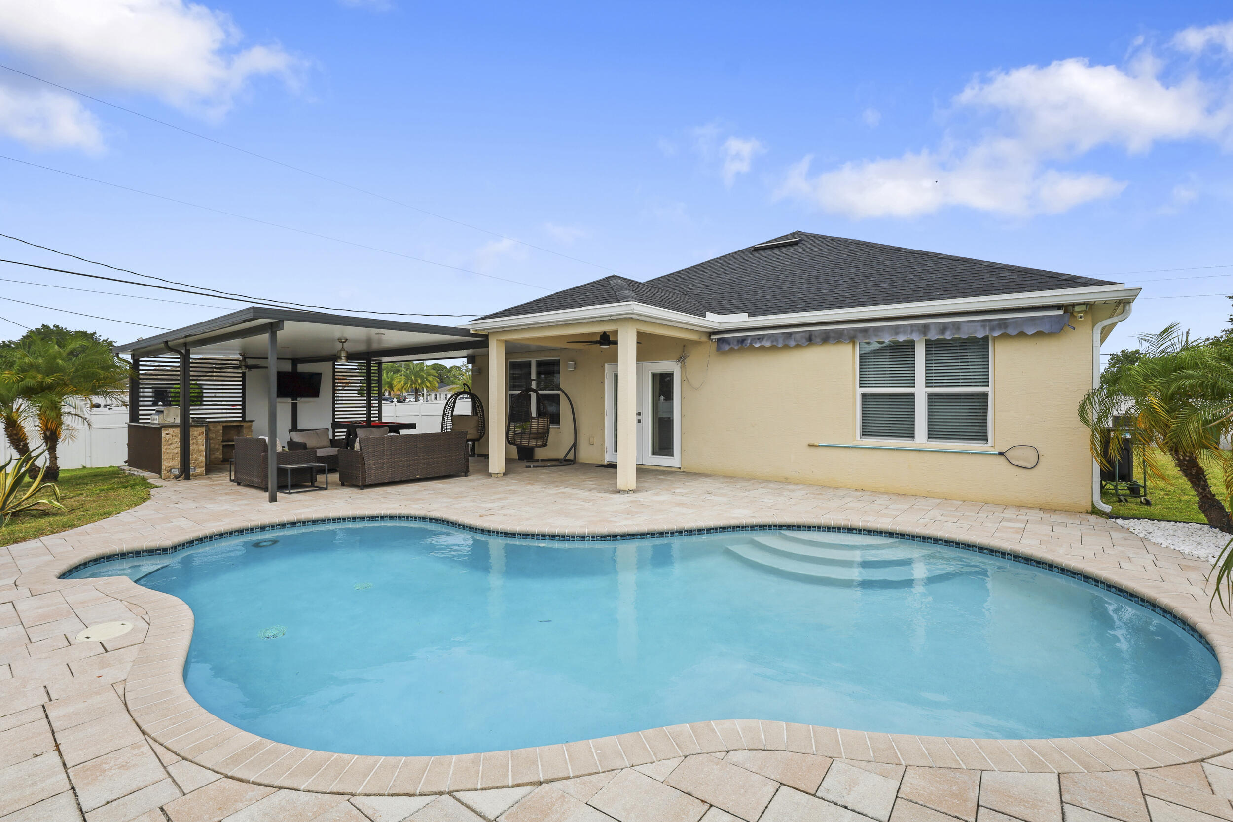 New roof 2024 - Built in 2018 - Fully fenced backyard - Corner lot - No HOA - Covered outdoor kitchen. Welcome to 275 SW Tulip Blvd in Port St. Lucie, a 4-bedroom, 2-bathroom, with 2 car garage. Step inside and enjoy a bright, open layout enhanced by upgraded light fixtures throughout. Outside is where this home truly shines — an amazing fully fenced backyard designed for unforgettable gatherings! Enjoy your private pool, expansive deck, and shed for extra storage. The outdoor space is built for entertaining with a covered outdoor kitchen and a dedicated area to relax and watch your favorite games poolside. Schedule your showing today.