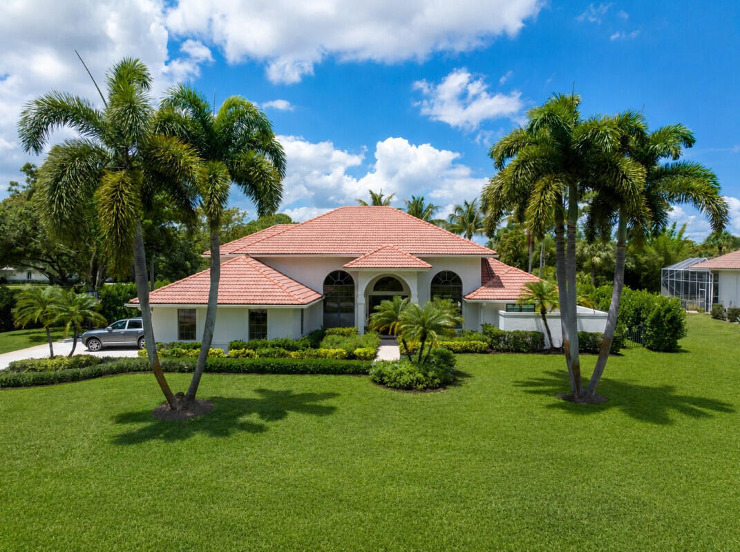 Set within Steeplechase, one of Palm Beach County's most prestigious guard gated communities,  this beautifully updated estate offers an exceptional blend of privacy, luxury, and refined Florida living. Situated on an oversized one acre corner lot, the property provides an extraordinary sense of space and exclusivity, surrounded by lush landscaping and estate-style homes where every residence sits on a minimum of one acre. Residents enjoy 24 hour manned security within this highly sought after Palm Beach Gardens enclave. Spanning approximately 4,291 square feet of interior living space, this exceptional residence features 4 bedrooms, 4 full bathrooms, a spacious loft, a three car garage, and soaring 18 foot ceilings that fill the home with natural light and create a grand sense of space.  surrounded by lush landscaping and estate-style homes where every residence sits on a minimum of one acre. Residents enjoy 24-hour manned security within this highly sought-after Palm Beach Gardens enclave.  Spanning approximately 4,291 square feet of interior living space, this exceptional residence features 4 bedrooms, 4 full bathrooms, a spacious loft, a three-car garage, and soaring 18-foot ceilings that fill the home with natural light and create a grand sense of openness throughout.  Designed for seamless indoor-outdoor living, the expansive backyard serves as a true private retreat featuring a heated resort-style swimming pool and spa, a custom playground, and a fully equipped outdoor kitchen complete with a built-in grill — perfect for enjoying South Florida's year-round lifestyle. The entire backyard is fully fenced, providing both privacy and peace of mind while enhancing the home's family-friendly appeal.  Inside, the home has been thoughtfully enhanced with sophisticated finishes and elevated design throughout. The spacious kitchen is both functional and beautifully appointed, featuring a Sub-Zero 48-inch Pro refrigerator and a charming breakfast nook that creates the perfect setting for casual dining and morning gatherings. The crown jewel of the home is the completely renovated primary suite — a true sanctuary designed with the feel of a five-star resort.