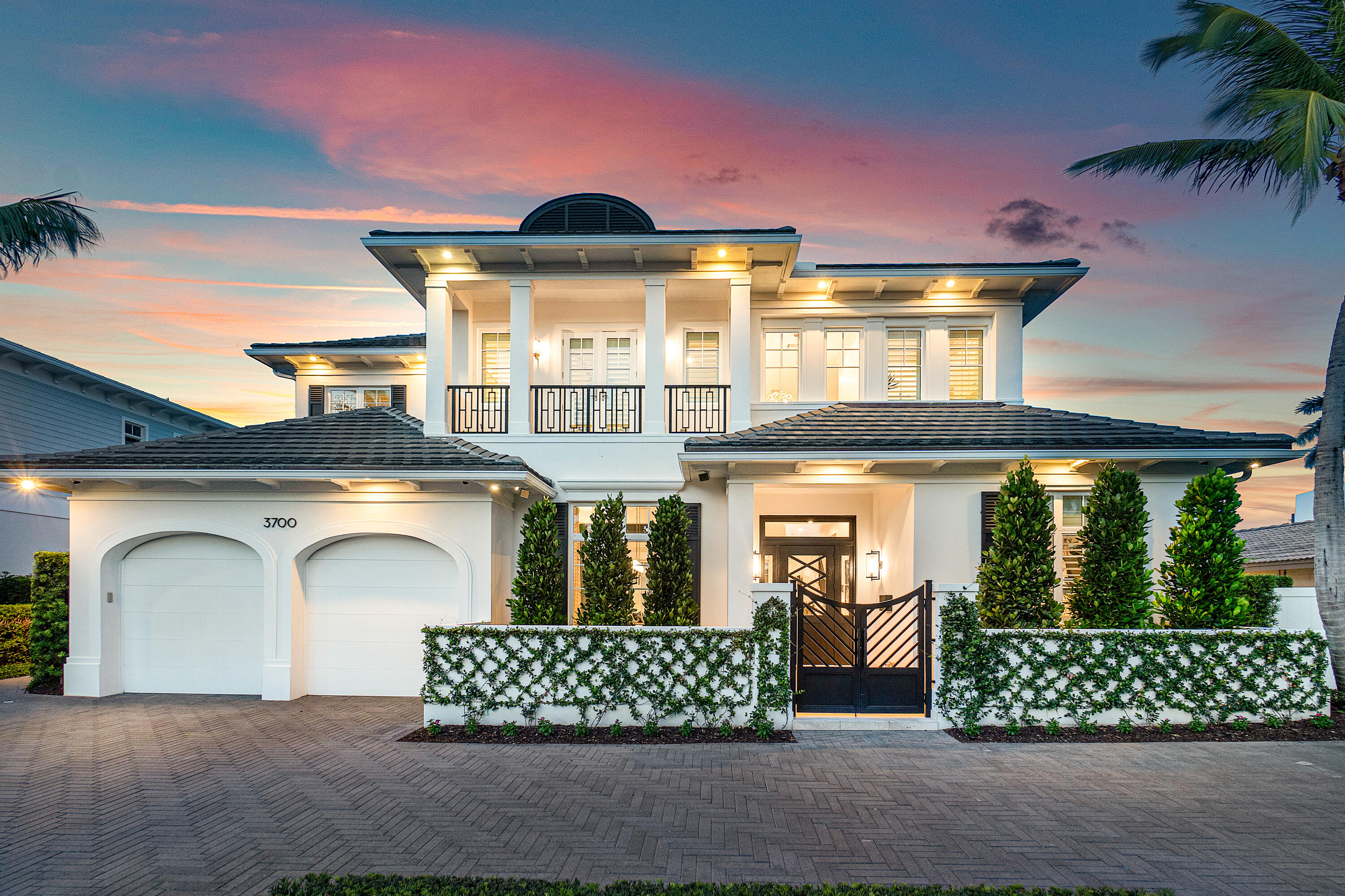 Experience unparalleled luxury in this breathtaking 5,494 living SF waterfront estate in Lake Rogers Isle. This exquisite property boasts 5 bedrooms (or 4 with a den), 5 full & 1 half baths, & an office; all meticulously designed for the ultimate in coastal modern living. The heart of the home is a gourmet kitchen w/ elite appliances, Dekton porcelain countertops w/ a matte finish, & Azzuri cabinetry, perfect for the culinary enthusiast. The primary suite stuns w/ water views, a spa-like bathroom & an outfitted closet. Outside you'll find a breathtaking infinity edge pool & spa, offering panoramic views of the wide canal leading to the Intracoastal Waterway w/ 75 ft of docking space. This home offers the epitome of coastal living, elegance, comfort, & an unbeatable waterfront location No expense was spared with this estate's 2021 reimagination, making this home truly one of a kind. Featuring four bedrooms, 5½ baths, an office, plus a den or 5th bedroom, this home is replete with professional designer appointments throughout. As you pull up to this estate you immediately notice the stately appeal with herringbone circular drive and meticulously manicured verdant landscaping. Step through the custom 8' Brazilian Mahogany front door into the foyer where you are greeted by pristine wide plank white Oak floors that are lit by a trinity of John-Richard Collection spherical quartz chandeliers. As you walk through the foyer and into the Great Room, you pass the thoughtfully designed formal dining room, complete with walls clad in a deep iridescent blue Phillip Jeffries grass wallpaper, Kelly Wearstler designed chandelier, and temperature-controlled wine cellar for the wine aficionado. The foyer opens into the Great Room, where you are met with panoramic water views. The Great Room is an open and voluminous space, with a multi-tray ceiling inset with white tongue and groove planks. The perfect space for entertaining, the Great Room spills out onto the covered patio and outdoor gas fireplace almost seamlessly, as you step through the 10' impact sliders. As in every room, this space features surround sound speakers to create an inviting environment. 

The kitchen steals the show with Viking double ovens, 8 burner gas range, microwave, and dishwasher and a handleless Dacor side-by-side refrigerator and freezer. The two tone Azzuri cabinetry blends effortlessly with the matte-finish Dekton waterfall countertops, backsplash and integrated sink, all accented by Kelly Wearstler pendant lighting. The space also offers an expansive island, a Butler's pantry with coffee bar, and plentiful storage. The kitchen opens to the breakfast nook, which is distinguished by a white, multi-medium Arterior chandelier; all overlooking the serene pool and patio space. Crossing back through the Great Room, you'll find a bonus room, which could act as a casual family room or fifth bedroom. This room is elegantly designed with Phillip Jeffries water hyacinth, two-tone wallpaper, a Visual Comfort pendant light, inset barn door, and bespoke woodwork. The ensuite cabana bathroom is equally appealing with designer wallpaper and Currey & Company lighting. 

Completing the first floor are a powder room and spacious office. The powder room is adorned with seashell inlaid wallpaper and Kelly Wearstler sconces. The office features coffered ceilings inlayed with grass wallpaper, built in custom cabinetry, deep iridescent blue Phillip Jeffries grass wallpaper, and plantation shutters. Ascending the staircase, you are welcomed by a comfortable loft with room for a couch or study nook that overlooks the entry way. The loft leads to a double-door entry into the primary suite.

The primary suite is spacious, serene, and intimate, featuring a spa-like bathroom, morning/evening bar and sitting area with sumptuous Phillip Jeffries grass wallpaper and Arterior light fixtures. As you enter the suite, immediately to your left is a morning/evening bar with beverage refrigerator to enjoy your morning coffee or a nightcap at the end of the day. Moving down the hall you are greeted by double doors leading to a fully outfitted closet with dressing vanity and chandelier.  As you leave the dressing area, you have a luxurious bathroom that features double vanities, a large walk-in shower, a soaking tub perfect for pampering, and a private water closet. A private oversized balcony with water views completes this magnificent space.

Moving out of the primary suite and down the hall you will find 3 additional bedrooms all with wood floors, outfitted closets, plantation shutters, and ensuite bathrooms. The last bedroom stuns with water views, a tray ceiling inlayed with designer wallpaper, and a Regina Andrew candelabra. The ensuite bathroom features a gigantic walk-in shower with soaking tub inside and an artistic tile accent wall. All the bedrooms are expertly decorated and designed with wallpaper from Holly Hunt, Cole & Son and Phillip Jeffries and light fixtures from Arteriors. Each of the ensuite bathrooms are unique and custom designed. 

Taking the elevator back to the first floor, you'll cross the Great Room and make your way to the pool and outdoor living area. Dine alfresco in the summer kitchen, complete with grill, prep sink, beverage drawers, and pizza oven. Relax in the cooler months next to the gas fireplace. Or lounge on the marble deck overlooking the infinity edge heated saltwater pool and spa. The pool and spa were included in the reimagination with new tile and finish. Steps down from the pool deck you will find a private deepwater dock that can accommodate up to an 80-foot yacht. The dock currently has 2 floating jetski docks and is conveniently located on an interior canal basin with Intracoastal views. 

Other details that are not to be overlooked are full impact glass, full home generator, Smart Home system, Lutron lighting, outdoor perimeter security cameras, 2 car garage with circular driveway, 2 newly replaced AC units, and gas tankless hot water heaters.
This home impresses on all levels and won't last long!