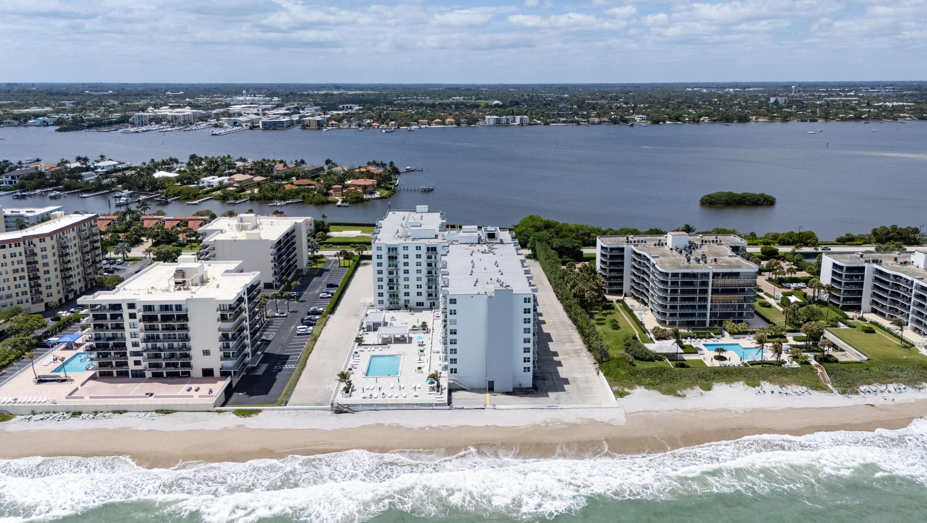 Perched on the coveted east side of The Patrician of Palm Beach, this residence captures sweeping ocean views that span the main living areas and both bedrooms. Mornings begin with sunrise vistas from the private balcony, while gentle coastal breezes and the rhythm of the shoreline set a relaxed tone throughout the day; an ideal expression of effortless oceanfront living. A well-conceived split-bedroom layout offers both privacy and functionality, complemented by continuous Spanish tile flooring that adds warmth and cohesion throughout the home. The kitchen has been thoughtfully updated with newer cabinetry, stainless steel appliances, glass shelving accents, and a reverse osmosis water filtration system creating a clean, efficient space suited for both everyday living and entertaining.  The primary suite serves as a peaceful retreat, featuring a fully renovated bathroom completed in 2023. Meticulously maintained with meaningful upgrades, the residence also presents a valuable opportunity for customization, allowing a new owner to further elevate its style and long-term value with selective cosmetic enhancements. Impact windows and doors provide added security and peace of mind. Residents of The Patrician enjoy a resort-style lifestyle, highlighted by a recently refreshed oceanfront pool, outdoor kitchen and lounge areas, private beach access, and a well-equipped fitness center. With its expansive ocean views, solid improvements, and potential for personalization, this home offers a rare combination of comfort, flexibility, and premier coastal living in one of Palm Beach's most established oceanfront communities.