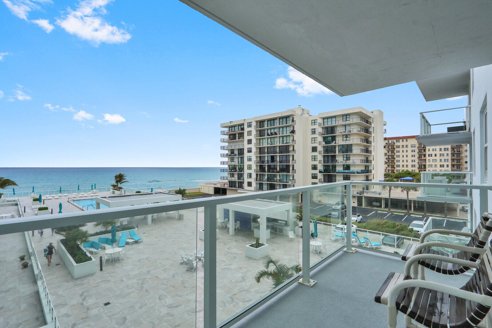 Perched on the coveted east side of The Patrician of Palm Beach, this residence captures sweeping ocean views that span the main living areas and both bedrooms. Mornings begin with sunrise vistas from the private balcony, while gentle coastal breezes and the rhythm of the shoreline set a relaxed tone throughout the day; an ideal expression of effortless oceanfront living. A well-conceived split-bedroom layout offers both privacy and functionality, complemented by continuous Spanish tile flooring that adds warmth and cohesion throughout the home. The kitchen has been thoughtfully updated with newer cabinetry, stainless steel appliances, glass shelving accents, and a reverse osmosis water filtration system creating a clean, efficient space suited for both everyday living and entertaining.  The primary suite serves as a peaceful retreat, featuring a fully renovated bathroom completed in 2023. Meticulously maintained with meaningful upgrades, the residence also presents a valuable opportunity for customization, allowing a new owner to further elevate its style and long-term value with selective cosmetic enhancements. Impact windows and doors provide added security and peace of mind. Residents of The Patrician enjoy a resort-style lifestyle, highlighted by a recently refreshed oceanfront pool, outdoor kitchen and lounge areas, private beach access, and a well-equipped fitness center. With its expansive ocean views, solid improvements, and potential for personalization, this home offers a rare combination of comfort, flexibility, and premier coastal living in one of Palm Beach's most established oceanfront communities.