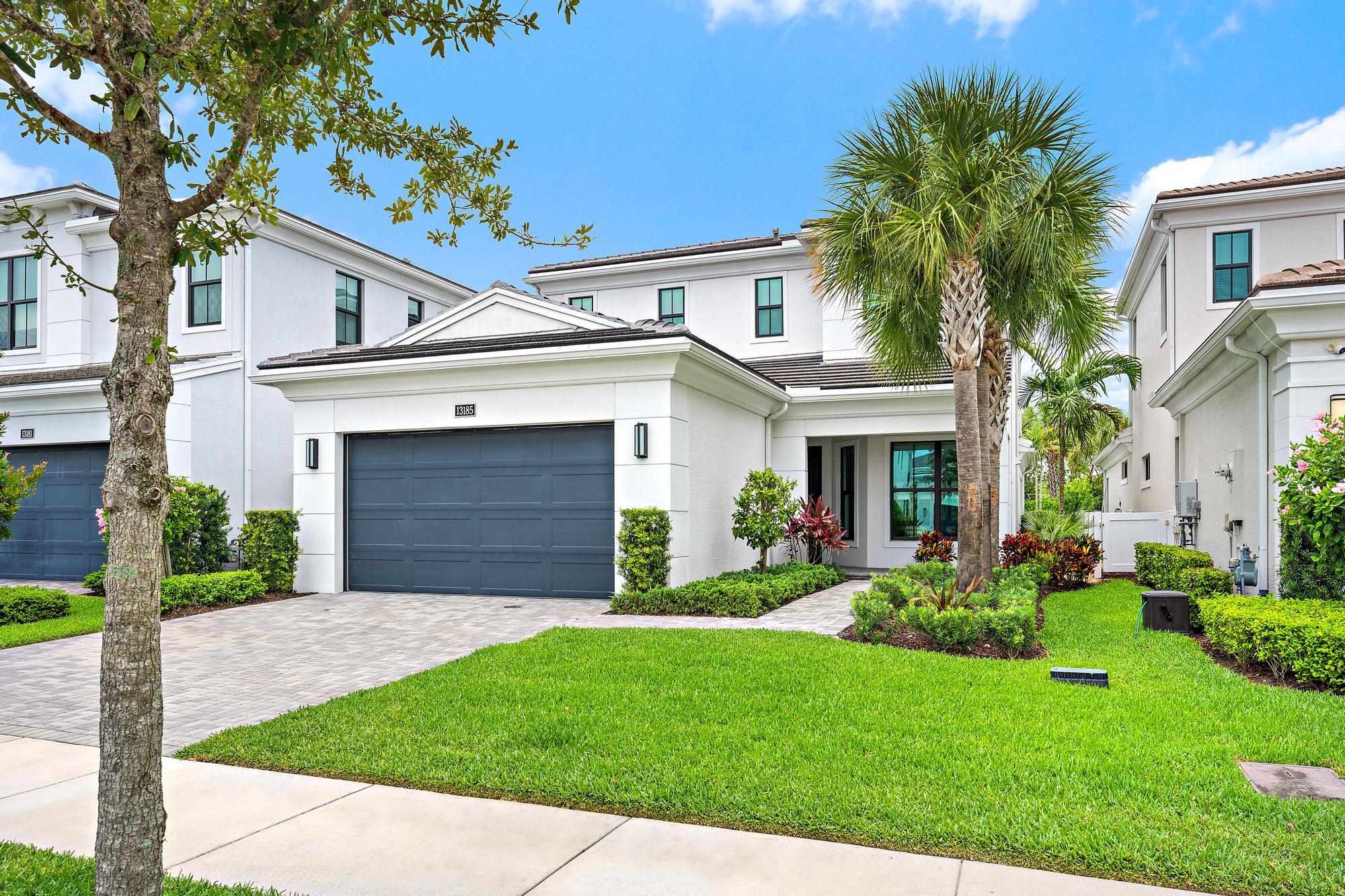 A thoughtfully upgraded Francesca model in Artistry, offering over 3,100 square feet, a first-floor primary suite, and a layout that feels equally suited for entertaining and everyday living. The kitchen anchors the home with waterfall-edge quartz countertops, flat-panel cabinetry, designer finishes, stainless steel appliances, and seamless flow into the main living spaces. Brand-new Mohawk engineered wood flooring enhances the first level, while wood flooring continues throughout the second floor.  The covered lanai extends the living space outdoors, overlooking a backyard with ample room for a future pool. Built in 2023 with impact glass throughout, this 3-bedroom, 3.1-bath residence combines modern construction with carefully selected upgrades.  Residents of Artistry enjoy a resort-style clubhouse, fitness center, pool, basketball court, walking trails, and playground, all minutes from Alton, PGA Boulevard, championship golf, beaches, I-95, and the Florida Turnpike.