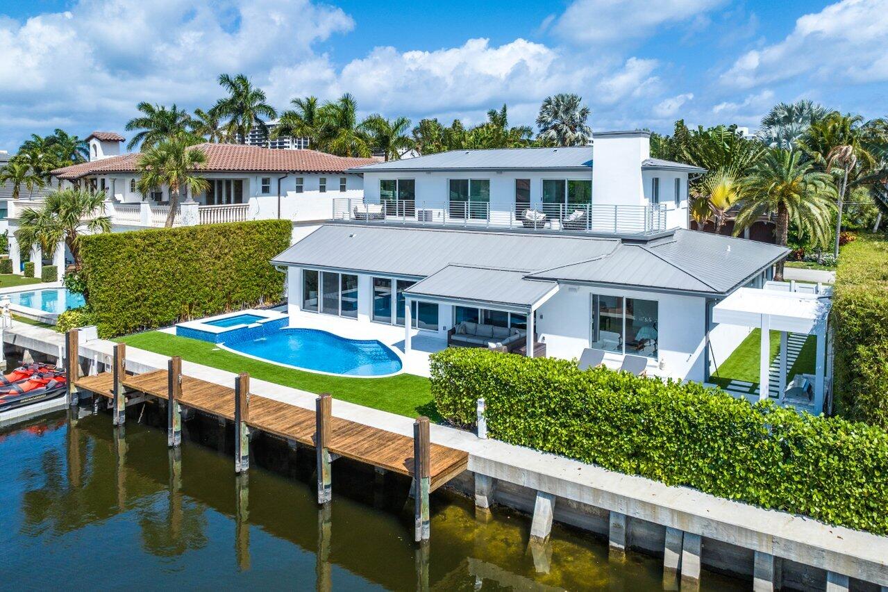 Now Presenting 7001 NE 8th Drive, A Stunning Waterfront Home that has been meticulously renovated from top-bottom. Situated as one of 45 Private Homes on Boca Harbor Island. This property offers irreplaceable views of the extra wide 120 ft deep-water turning basin creating a picturesque setting for our beautiful South Florida Sunsets. The home has a newer seawall that spans 87ft, with plenty of room for multiple water toys and boats with no fixed bridges to the ocean or Intracoastal, truly a boater's ideal set-up. Enjoy the resort-style backyard year-round, with a Saltwater heated pool and spa, Power Louvered Pergola/ Grill Station, and lush landscaping. The wall of window sliders to the backyard is an entertainer's dream and emphasizes indoor-outdoor living at its finest. Upon entering the foyer, you are greeted by an impactful water view while able to appreciate the high-quality finishes/fixtures and stunning staircase with glass railings. Enjoy having a complete control 4 smart home system by turning on music, controlling your lighting, and automating your window shades. The kitchen is the heart of the home with sweeping water views, a Gas cooktop, a Franklin Kitchen Sink with Pfister Hardware, and a proper wolf appliance package with two ovens and wall microwave, a wine cooler, and mini fridge. The first-floor floorplan is fantastic with an open-concept kitchen, waterfront dining room, and living room with a Linear Electric Fireplace and hardscaped TV built-in with endless views of the canal.. Two more proper bedrooms are located downstairs, the furthest west bedroom offers an ensuite bathroom and beautiful water views, while the front bedroom offers a hall bath, and private views of the lushes front and side yard gardens. Entering upstairs you will be stunned by the 400 SQFT terrace with multiple access points giving you an incredible vantage point of the water and resort-style backyard. The terrace is simply a beautiful space for sunset cocktails or morning coffee while the sun is rising in the front yard of the home. Stepping off the terrace you are appointed with a well-sized Primary Bedroom offering fantastic ceiling height, water views from laying in bed, and an efficient walk-in closet system. The Primary Bathroom is a dreamy owners retreat, with floor-to-ceiling tile, a signature hardware floating tub, Sonos speakers, and everyone's favorite toto toilet. The 4th bedroom also has access to the terrace and features its very own ensuite bathroom with Helious LED mirrors and high-end Delta fixtures. Additional features include impact windows/doors, a 500-gallon propane tank, 2019 metal roof, and a whole-home generator for peace of mind.

Embrace the East Boca Raton lifestyle at Boca Harbor Island, offering proximity to Boca Raton's amenities and Delray Beach's Atlantic Avenue nightlife. Live and love the waterfront lifestyle at 7001 NE 8th Drive!
