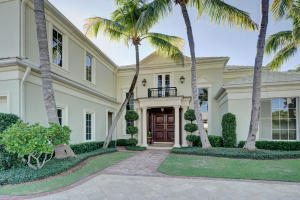 Two story home in Royal Palm Yacht & Country Club on 95' of waterfront with direct Intracoastal & Ocean access. Home sits on the Butterfly Palm Waterway and has private dock with shore power, LED lights, and water. Features include front and back staircases, movie theater with stadium seating and bar area, gourmet kitchen with top-of-the-line appliances and large walk-in pantry, library with custom built-in shelving and wet bar, two-story formal living room, formal dining room, 1st floor master suite, all impact glass windows & doors, whole house generator, natural gas, and 4-zone air conditioning. Two covered patios, heated pool & spa, lush tropical landscaping for privacy, front circular marble driveway and a 3 car garage with built-in storage cabinets.