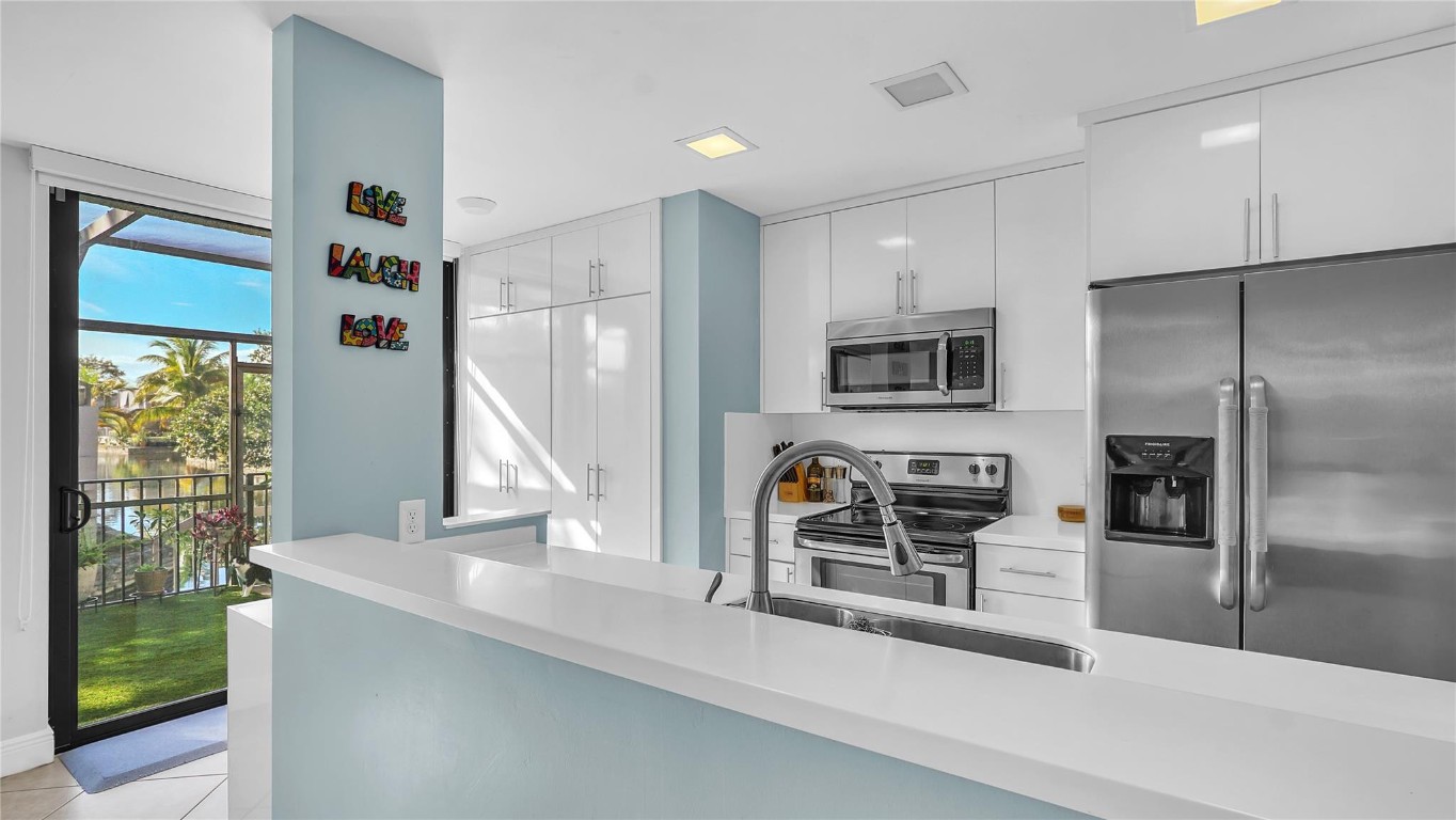 Experience modern living with this stunning split-level home, boasting a spacious & bright interior. Main level offers vast open living space w/separate dining & family room perfect for entertaining. Stylish kitchen w/sleek quartz countertops, undermount sink, ample cabinetry +pantry. Serene views of the canal add a tranquil backdrop to your daily living while the expansive screened patio adds an ideal spot for relaxation or hosting gatherings! Second floor has cherry wood flooring in all three generously sized bedrooms. Bathrooms have been elegantly remodeled, adding a touch of luxury to your new space. Walk-in closets, impact windows & doors + roof replaced 2016! The neighborhood offers fantastic amenities with pool, tennis courts,  racquetball, basketball, cable and navigable canal!