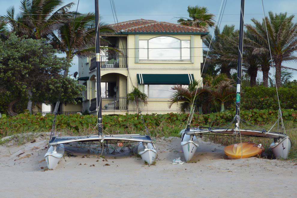 Incredible opportunity to own a rare oceanfront home with an elevation 23 feet above sea level. Ideally located just blocks north of Atlantic Avenue and Downtown Delray Beach and south of George Bush Boulevard, this is one of the few oceanfront parcels along the stretch of A1A. The location is second to none and the home is truly spectacular with absolutely amazing unobstructed ocean views. The home sits on a deep corner lot allowing privacy and expansive space. Original structure from 1951 was rehabbed in 1997 with expansive new addition added on. Major update in 2005 included roof, floors, windows, paint, landscape and more to create a like-new residence. Interior features include lavish master quarters, gourmet kitchen overlooking the ocean with top-of-the-line appliances, formal library with built in bookcases, formal dining, large media room, custom finishes throughout, and a private guest apartment. The exterior of the property offers expansive outdoor space; filled with lots of lush tropical landscape and a tree canopied entrance. The elevation and location of lot provide peace of mind since it is not in a flood zone. The coral loggia overlooks the oversized pool and the courtyard's fountain. The outdoor kitchen includes professional stainless steel gas grill and wood-burning pizza oven. Natural gas sconces light the loggia and four covered terraces overlooking the ocean. This home is wonderful for entertaining and extremely rare to find in Delray Beach.
