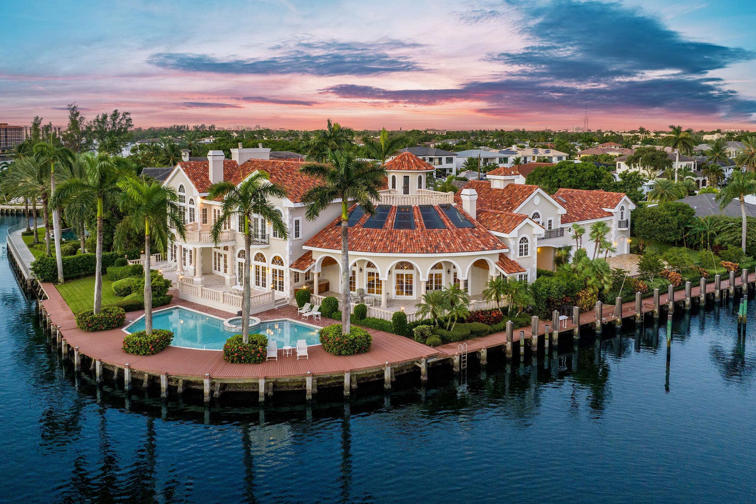EXTRAORDINARY VALUE: PRICE REDUCED BY $1,245,000. Presenting Villa Bellevue, an elegant European-inspired waterfront estate that embodies timeless sophistication. Nestled within the revered confines of Lake Rogers Isle, offering serene and unobstructed views of Spanish River Park and Intracoastal Waterway, Villa Bellevue stands as a tribute to classical elegance, beckoning those with the most discerning of tastes.

Step through the regal property gates and a world of refined beauty unfolds. This expansive 2.5-lot (0.74-acre) waterside estate boasts lofty 30'+/- soaring ceilings, robust concrete construction, a 5-car garage, and a total of 17,998+/- square feet, with approximately 12,340+/- square feet of interior living space. EXTRAORDINARY VALUE: PRICE REDUCED BY $1,245,000. Presenting Villa Bellevue, an elegant European-inspired waterfront estate that embodies timeless sophistication. Nestled within the revered confines of Lake Rogers Isle, offering serene and unobstructed views of Spanish River Park and Intracoastal Waterway, Villa Bellevue stands as a tribute to classical elegance, beckoning those with the most discerning of tastes., this substantial point-lot property showcases an impressive 369+/- feet of deep-water intracoastal and protected canal frontage, ideal for larger yachts, offering sweeping panoramic views of a private park and Lake Rogers.

The estate features 8 lavishly appointed bedrooms and 8.2 impeccably designed bathrooms. The interiors are a symphony of artistry, meticulously curated by the renowned Marc-Michaels Design. This visionary touch graces every corner with exquisite interior designs, harmonious hues, and rich textures - seamlessly blending timeless aesthetics with modern indulgences.

At the heart of this estate lies a state-of-the-art kitchen, where culinary passion converges with traditional craftsmanship. Adorned with sleek top-brand appliances and elegant granite finishes, this space transforms cooking into an art form. 

As you enter the outdoor setting, residents are greeted by a gas-operated summer kitchen, sparkling vistas, a pool reminiscent of a luxurious resort, and an inviting spa.

Within this sanctuary of grace and refinement, enveloped by the embrace of a private park and overlooking the tranquil waterfront, one can luxuriate in the essence.