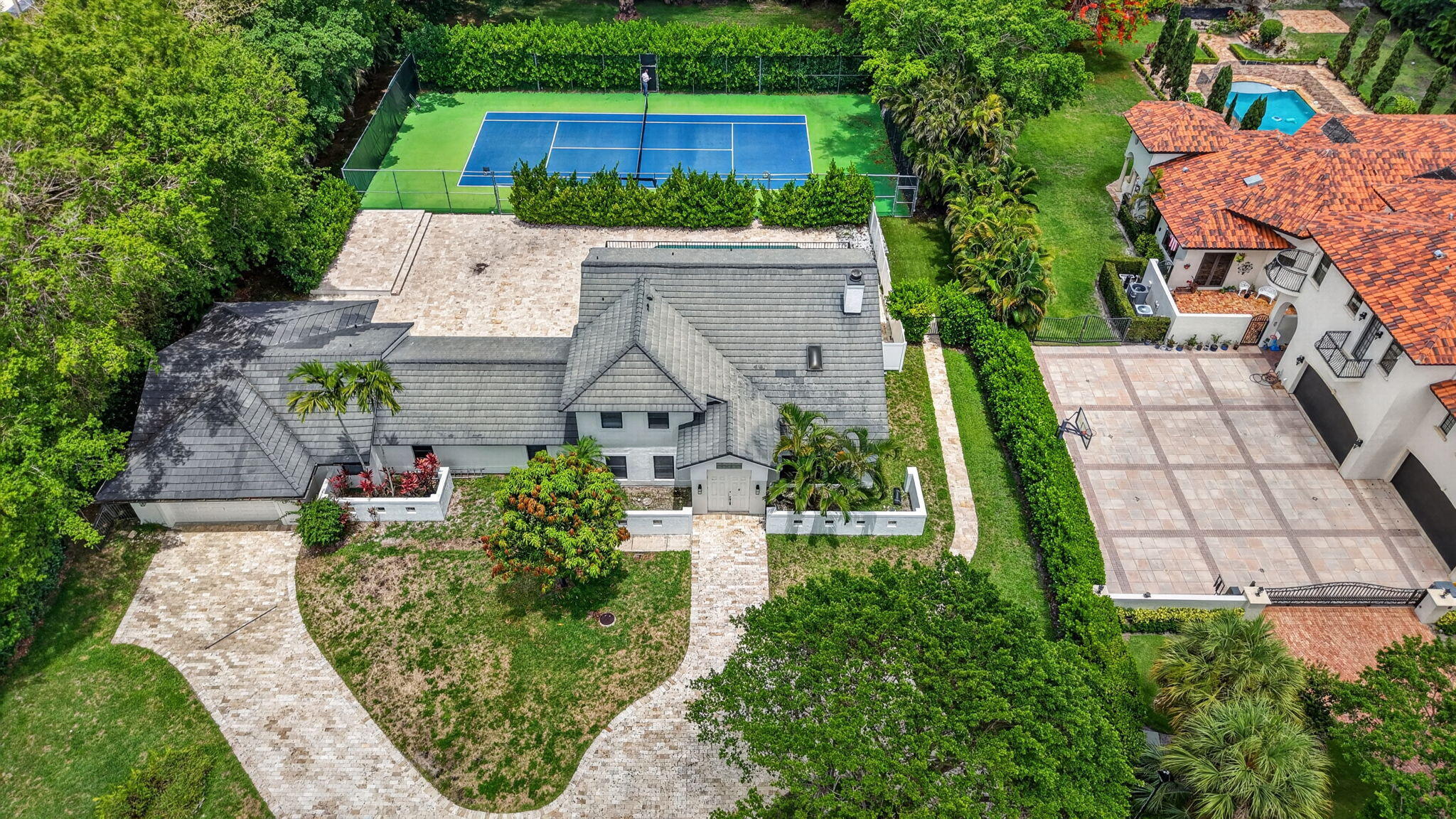 Welcome to 8044 Twin Lake Drive, a spacious 5 bed/ 4 bath home with over 4,100 square feet of living space situated on a generous 1.18 acre lot in prestigious Long Lake Estates. This meticulously refreshed estate features fresh interior paint and roof repairs. The pool has been redone and professionally pressure washed. A private tennis court and elegant marble paver driveway showcase the quality upgrades throughout.   Long Lake Estates is a 24-hour guard-gated community where each home sits on a minimum 1-acre lot among tree-lined streets and sparkling lakes. Centrally located in Boca Raton, minutes from I-95, shopping, dining, top-rated schools, and Atlantic Ocean beaches. This exceptional property offers sophisticated Florida living! Schedule your showing today!