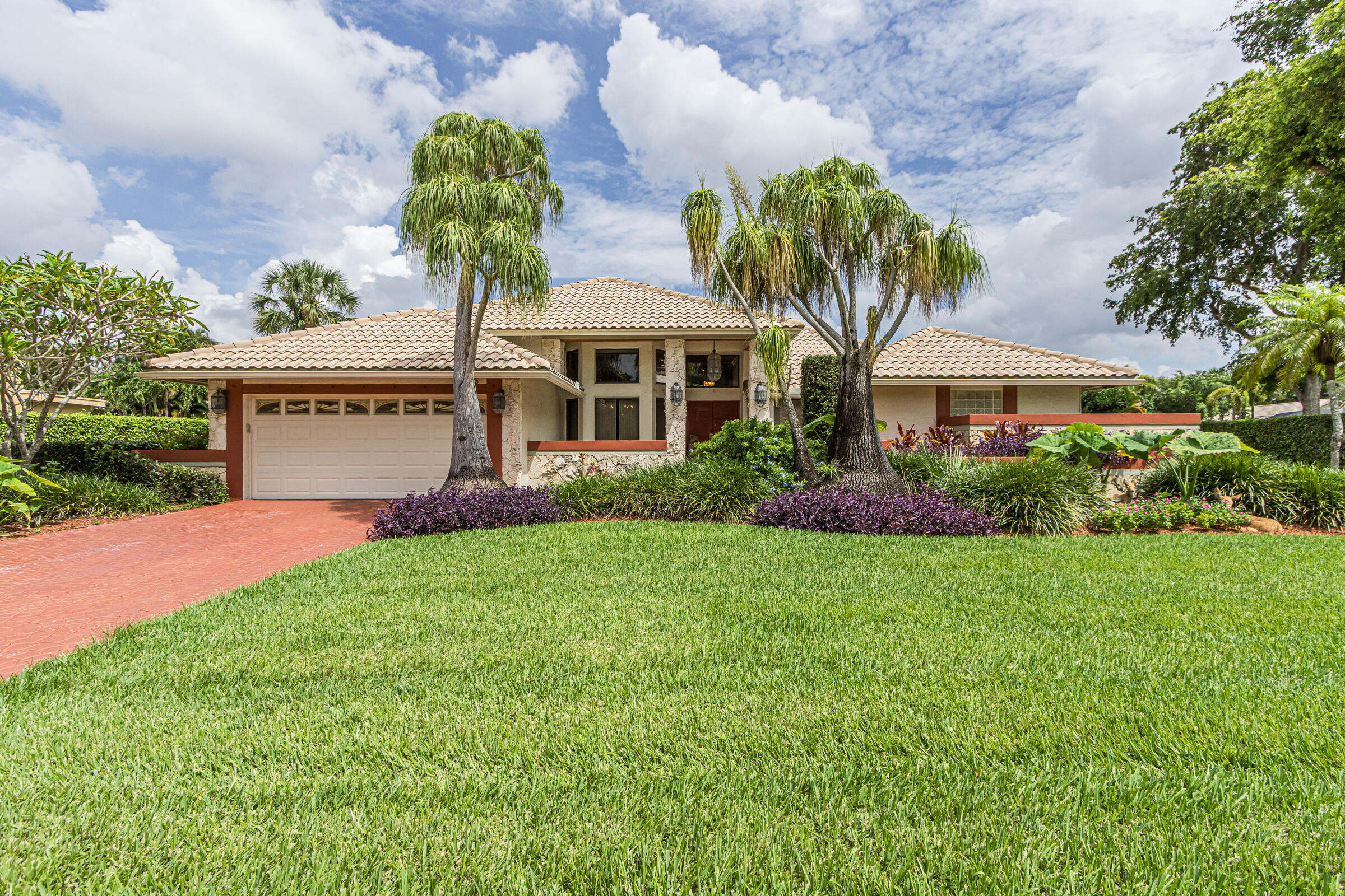Welcome home to this beautifully maintained 4-bedroom, 2.5-bath residence offering over 3,300 total square feet, including more than 2,800 square feet under air. Lovingly cared for by its original owners, this home showcases thoughtful renovations, exceptional upkeep, and true pride of ownership. Located in Pine Grove on a huge lot, the property offers privacy, space, and plenty of room to entertain.  The updated modern kitchen features stylish finishes, abundant cabinetry, walk in pantry and ample space for cooking and gathering. The inviting family room boasts a cozy wood-burning fireplace and a built-in bar, making it the perfect place to host family and friends. Step outside to your private backyard retreat, complete with a swimming pool and spa that provides plenty of space for relaxing, entertaining, and enjoying the Florida lifestyle year-round. The primary suite is a true retreat, featuring a large bedroom with a connected extra room—ideal for a home office, reading area, fitness space, or private lounge. Spacious living areas, updated features, hurricane protection including impact windows and meticulous maintenance make this property a rare find.   Conveniently located with easy access to the Sawgrass Expressway and Florida Turnpike, this home is within walking distance of an elementary school and just minutes from shopping, dining, and everyday conveniences. Don't miss this rare opportunity to own a spacious, beautifully updated home in a highly desirable location.