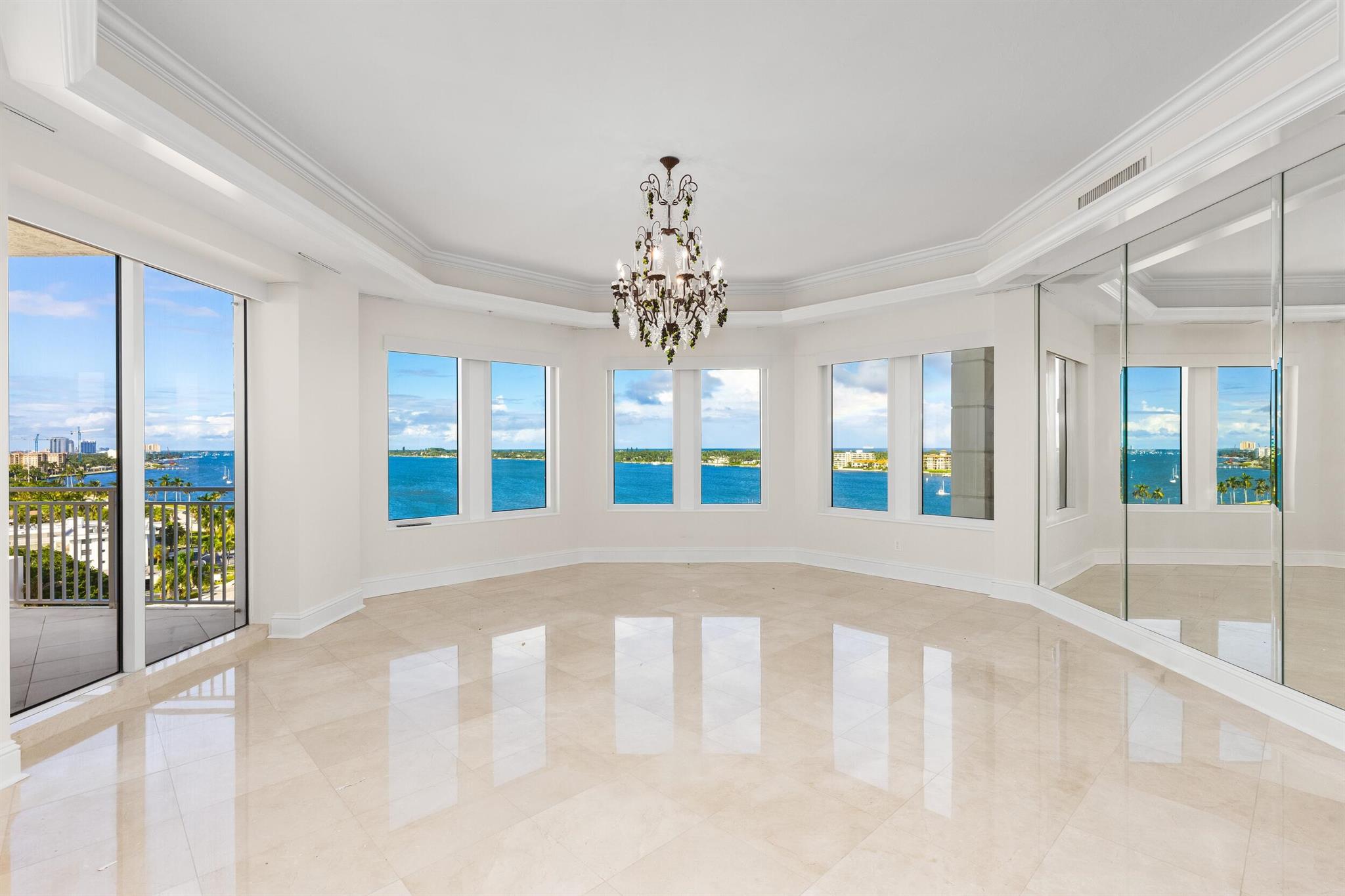Fantastic Lakefront condominium with over 6,000 total square feet, 4 bedrooms, 3 baths, and 2 powder rooms. Beautiful Intracoastal, Ocean, and Palm Beach views from all primary rooms. Fabulous indoor-outdoor living with four large waterfront covered terraces. Lovely grand salon and dining room are perfect for entertaining. Oversized chef's kitchen with island and butler's pantry leads to morning room and family room. Elevator opens to private vestibule, welcoming foyer, and stunning views. Spacious Primary Suite with terrace, large bath, and four walk-in closets. Each spacious guest suite opens to terraces with water views. Ample storage throughout and separate storage unit. Two garage parking spaces. With a recent significant renovation, the highly desirable One Watermark building offers world-class amenities, including gym, massage room, saunas, valet, dog run, spa, and pool.