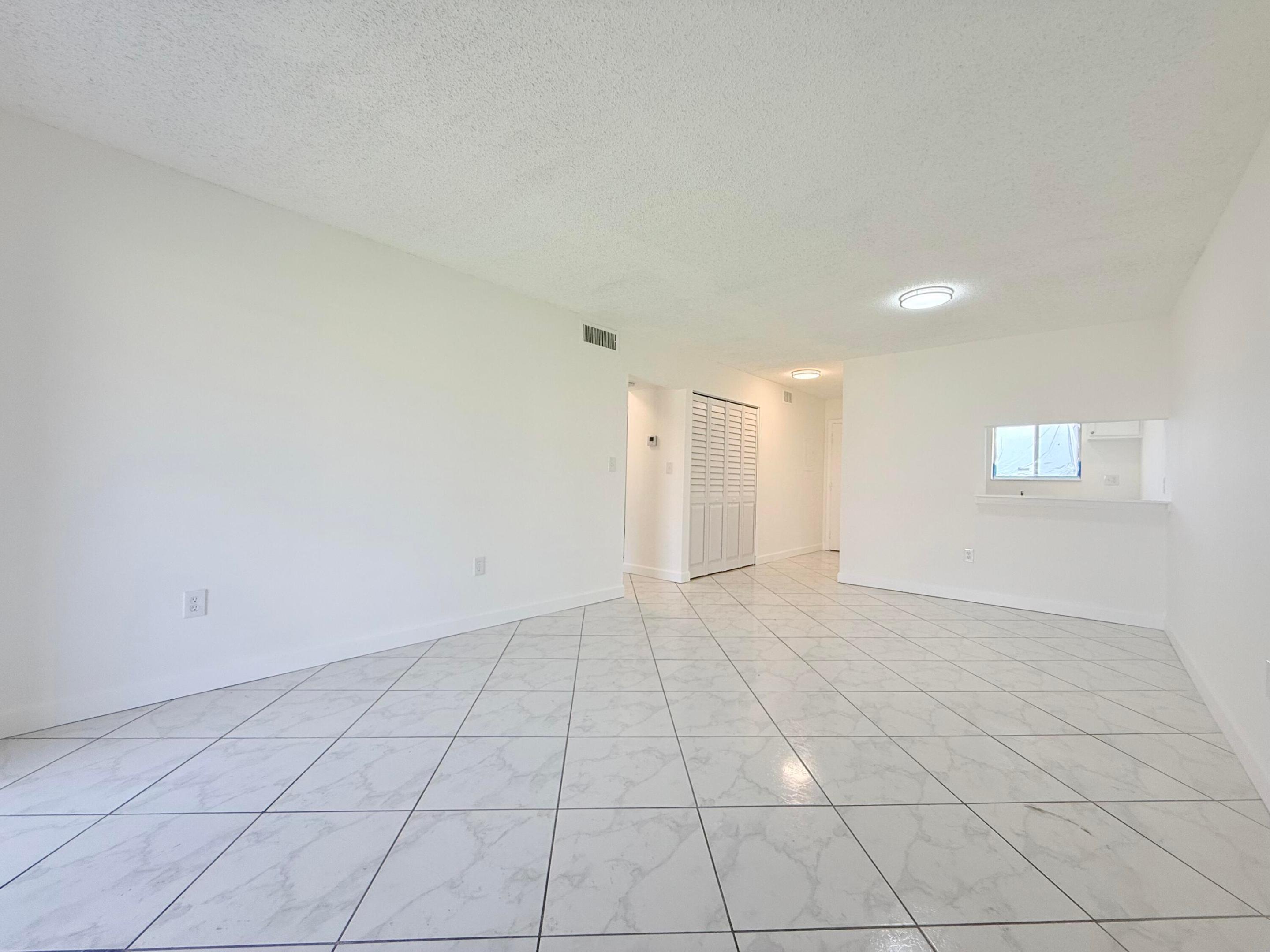 Beautifully renovated 2-bedroom, 1-bath second-floor condo offering bright, move-in-ready living. This inviting home features a brand-new kitchen with modern cabinetry and countertops, new appliances, an updated bathroom, new flooring throughout, and fresh interior paint. Major system updates include a 2022 A/C and 2022 water heater, providing added peace of mind. Enjoy your morning coffee or unwind on the private screened balcony. The community offers a pool, tennis courts, and assigned parking. Conveniently located near shopping, dining, schools, Palm Beach International Airport, and major highways.