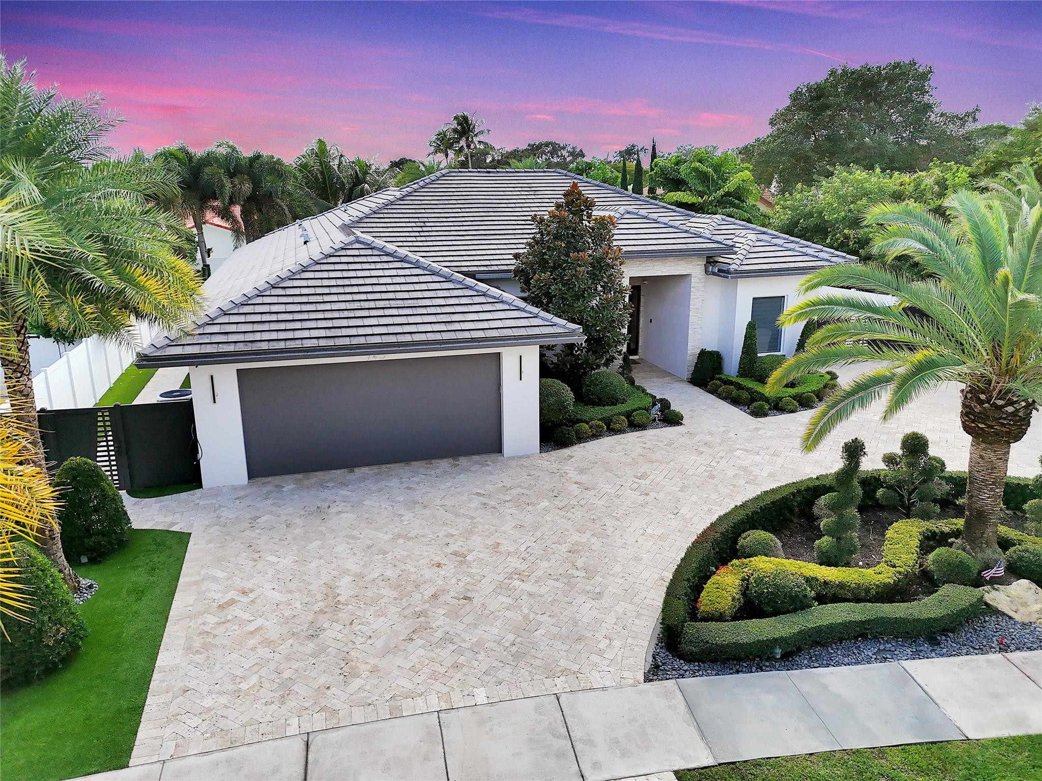 Discover unparalleled luxury in this custom-built residence, perfectly situated in East Boca Raton’s most desirable location. Meticulously crafted with premium upgrades—foam insulation, double-insulated walls, designer lighting, Sonos sound, and full security system. A chef’s kitchen showcases custom soft-close cabinetry, Crystallo stone surfaces, induction cooktop, KitchenAid appliances, and an elegant storage-rich island. The primary suite features a stunning Agatha stone accent wall and bespoke closets. Enjoy a resort-style outdoor oasis with a quartzite-clad summer kitchen, dual BBQs, travertine pavers, saltwater pool, custom shed, and PGT impact doors and windows. Experience luxury living in this custom-built residence, crafted with exceptional quality and thoughtful upgrades throughout. This immaculate home features full foam attic insulation, double-insulated exterior walls, flat ceilings with recessed lighting, a whole-home Sonos sound system, full camera surveillance, solid wood doors, and custom curtains.The designer kitchen offers custom soft-close cabinetry, Crystallo countertops with a porcelain slab backsplash, an induction cooktop, KitchenAid appliances, a wine cooler, exterior-vented exhaust fan, and an oversized island with storage on both sides.The primary suite impresses with a custom wood-panel feature wall accented by semi-precious Agatha stone, custom bathroom cabinetry, and fully built-out closets. The cabana bath is finished floor-to-ceiling in natural quartzite stone.Outdoor living is elevated with a fully equipped outdoor kitchen, including a striking avocado-green quartzite full-wall backsplash and two built-in barbecue styles. Enjoy travertine pavers, a saltwater pool, foam-insulated tongue-and-groove ceilings, custom landscaping, and a custom storage shed. Home is secured with PGT high-impact doors and windows.A rare opportunity to own a truly bespoke home with premium finishes and craftsmanship at every turn.