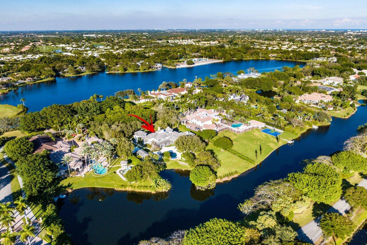This sophisticated and timeless French Chateau style, lakefront estate is on 2.43 acres inside Boca Raton's ultra-private, gated community— Le Lac. This estate's Park Avenue interior offers a large entertaining living room and family room that opens into each other as well as the outside loggia, formal dining room, three fireplaces, 5 large bedrooms, 5.5 bathrooms (two primary bathrooms), large closets, office, library, gym, game room, conservatory like eat in kitchen, three car garage. This property has a separate one bedroom apartment with full bathroom and washer/dryer over the garage. The home is situated in a park like setting featuring a pond style infinity pool with waterfall, koi pond, tiered sitting areas, summer kitchen and 1/2 court pad. Le Lac allows for boating & water sports.