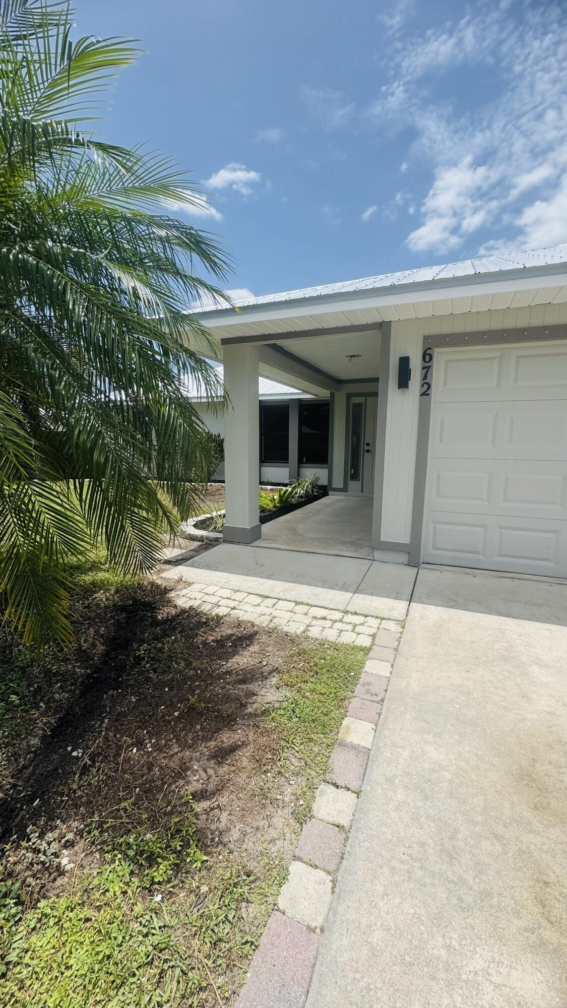 Beautifully renovated and move-in ready, this stunning Port St. Lucie home offers the perfect blend of style, comfort, and functionality. A brand-new 2026 metal roof provides peace of mind, while the thoughtfully updated interior showcases quality finishes throughout. The modern kitchen is a true showpiece, featuring sleek Quartz countertops, brand-new Samsung stainless steel appliances, contemporary cabinetry, and an open layout perfect for everyday living and entertaining. Both bathrooms have been beautifully remodeled with elegant Quartz countertops, designer tile, glass shower doors, and upscale finishes. The spacious primary suite is highlighted by a sophisticated, updated bath with gold fixtures that add a touch of luxury. One of the home's standout features is the additional    312 square feet of air-conditioned living space in the enclosed screened patio, offering endless possibilities as a family room, game room, home office, or fitness area. Step outside to a huge, fully fenced backyard with plenty of room to add the pool of your dreams while still leaving ample space for outdoor entertaining, pets, or play. Conveniently located near shopping, dining, schools, parks, and major roadways, this beautifully updated home is truly move-in ready and waiting for its new owners.